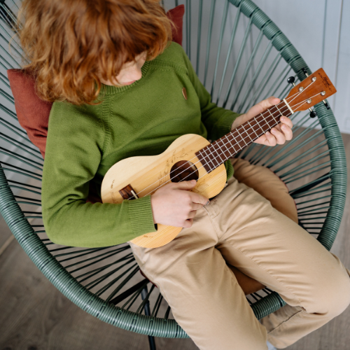 boy playing ukulele