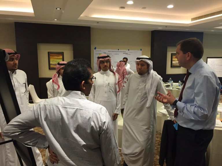 Bernie Smith talking with training group in Saudi Arabia