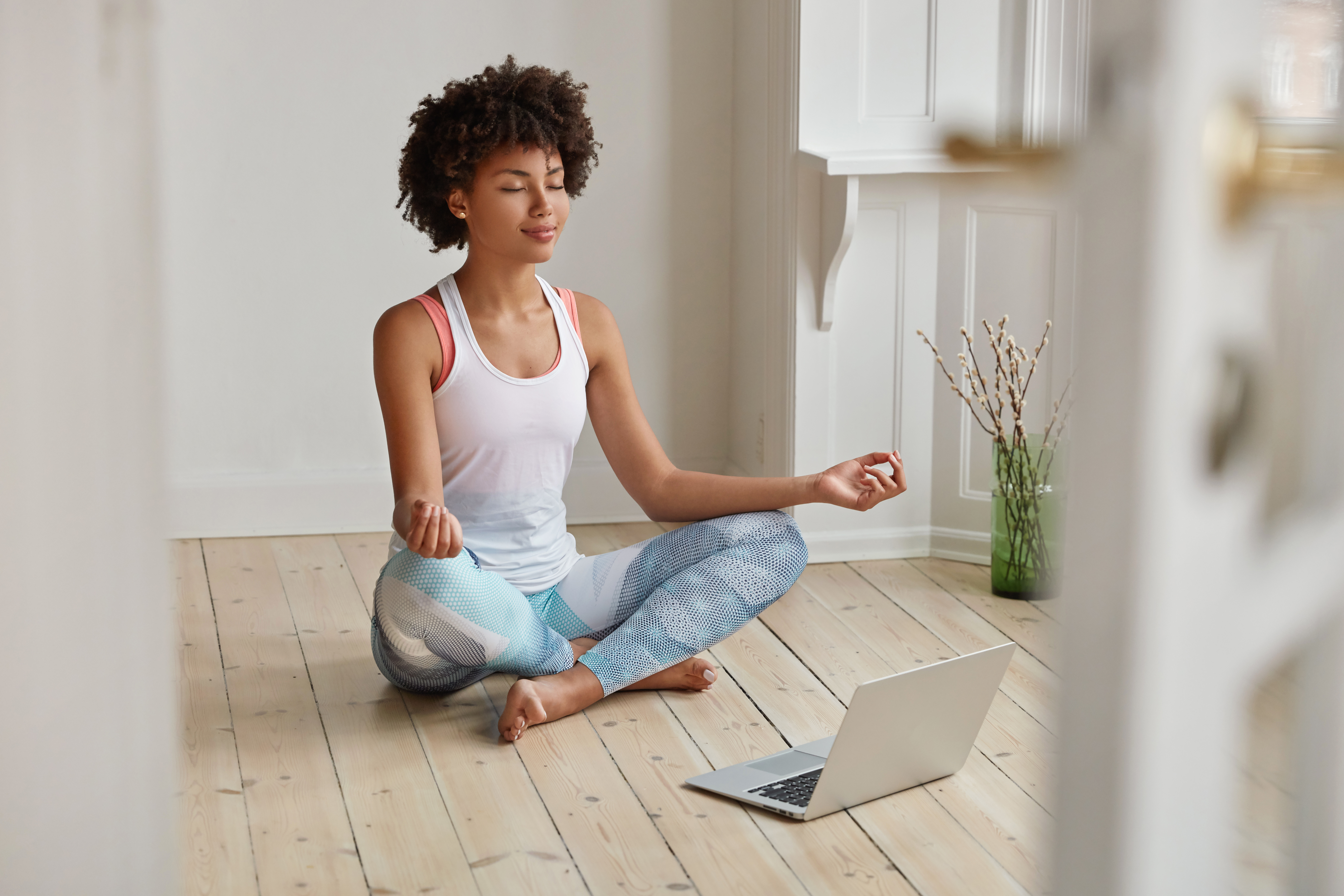 Woman in front of notebook meditating