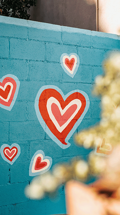 Hearts painted on a blue wall