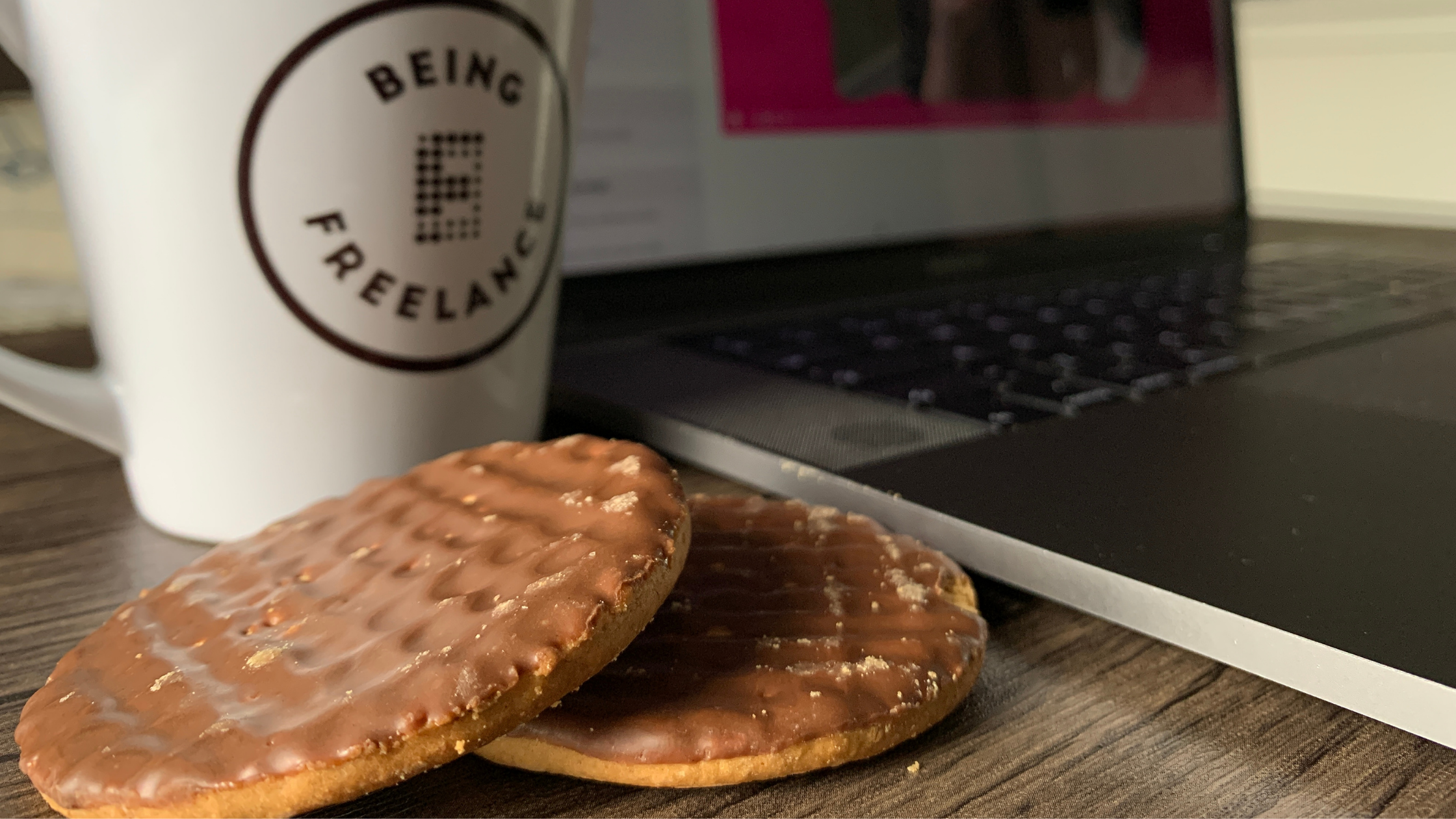 Being Freelance mug with two biscuits and a laptop showing the course