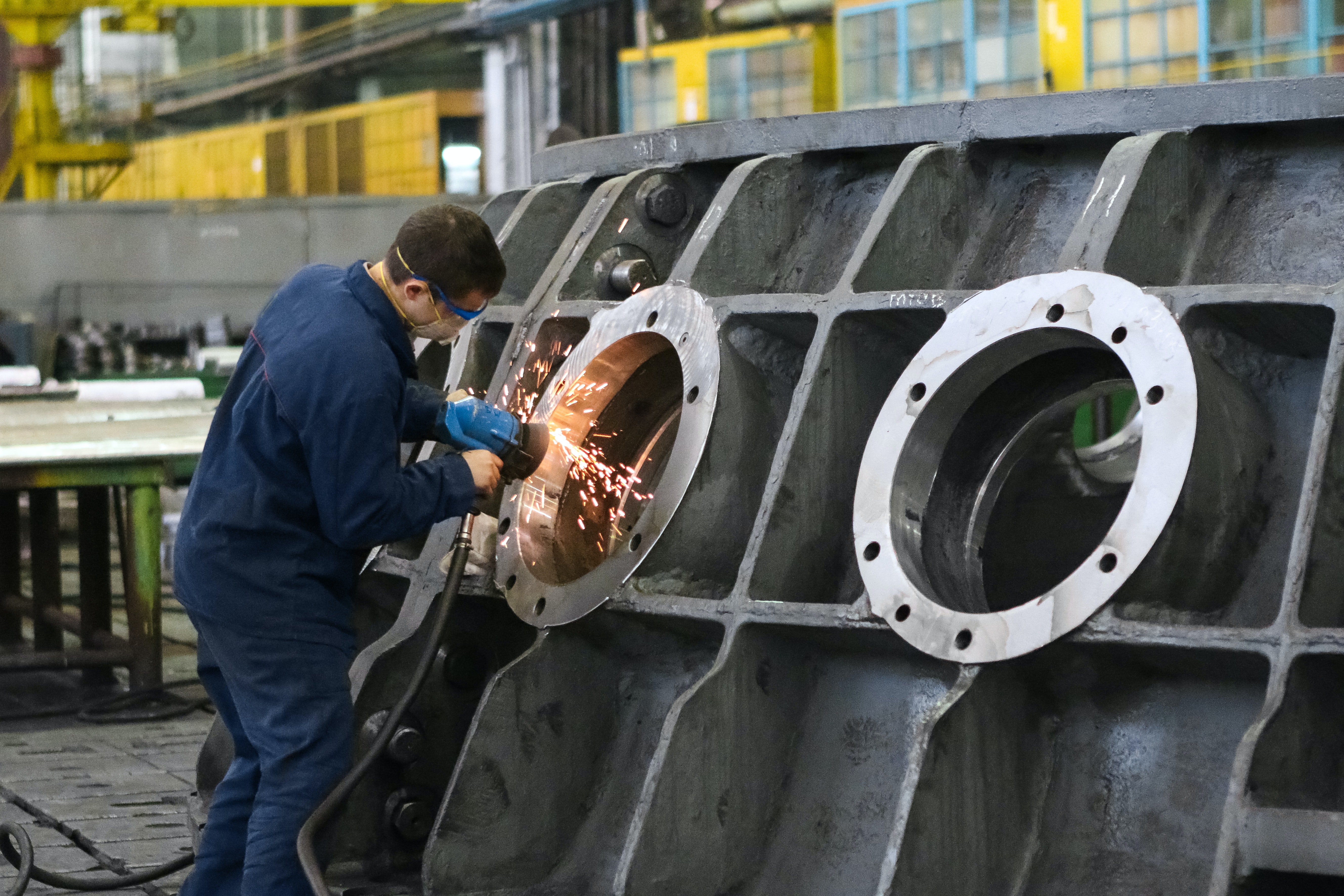 man welding in a manufacturing plant