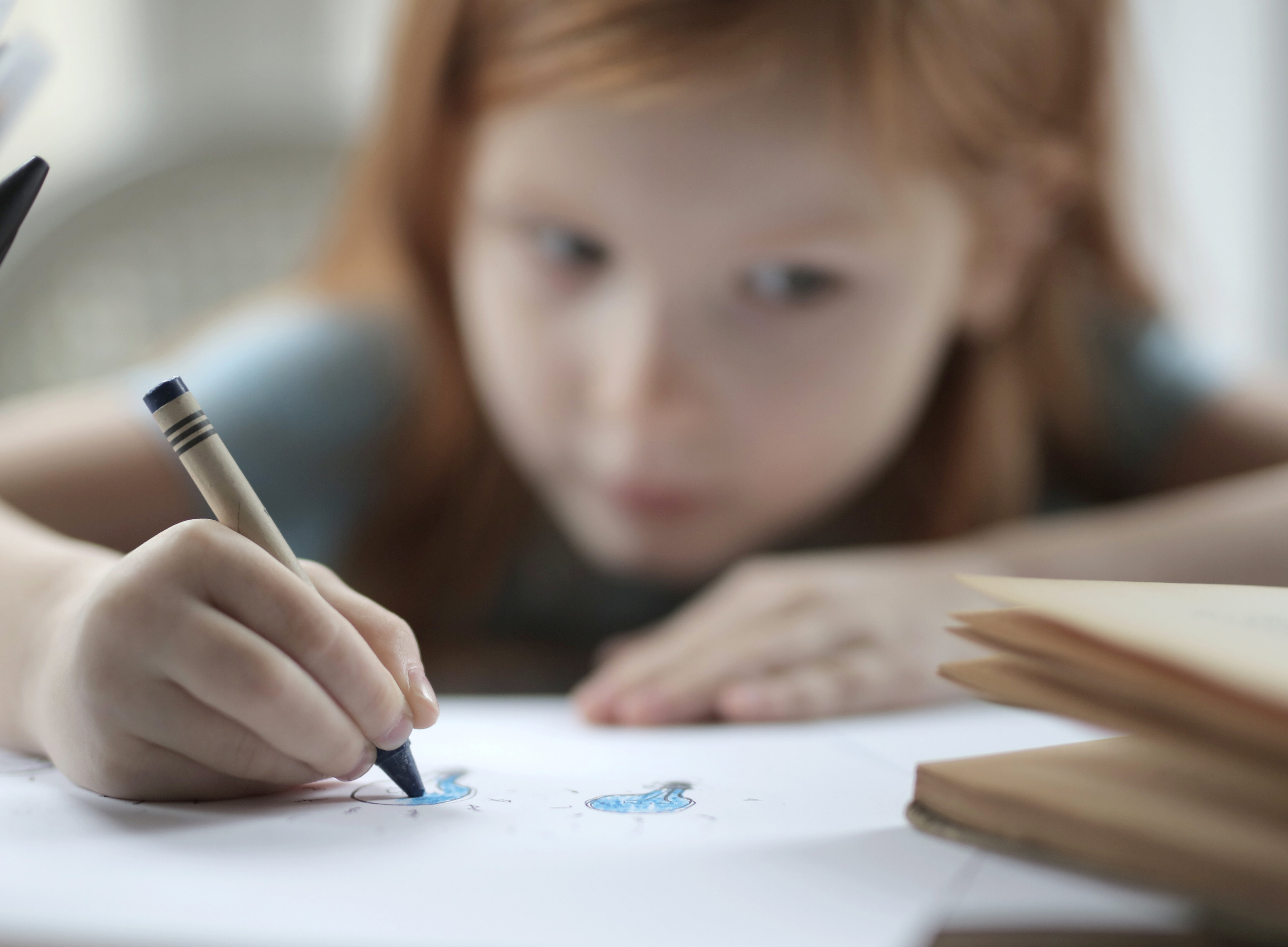 little girl with crayon