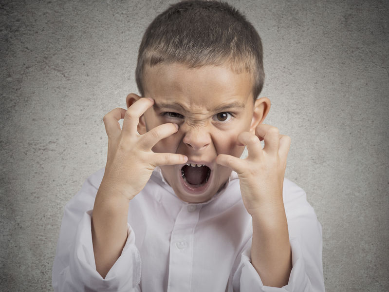 Boy with hands up obviously upset