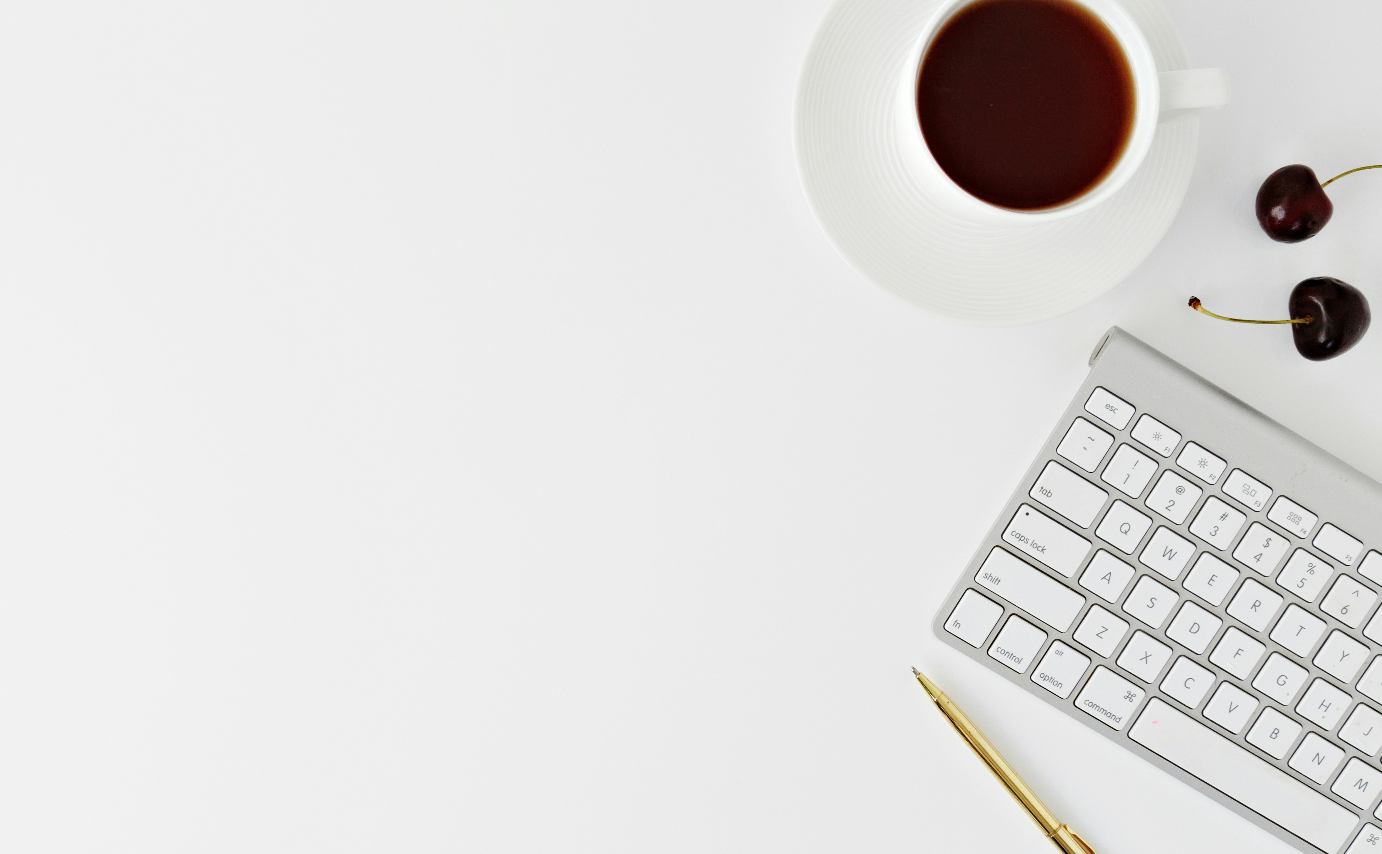 Decorative image of a table top with a keyboard and coffee cup