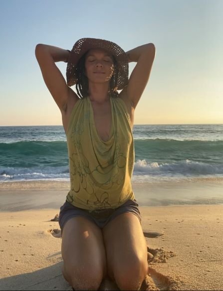 Woman on beach inhaling