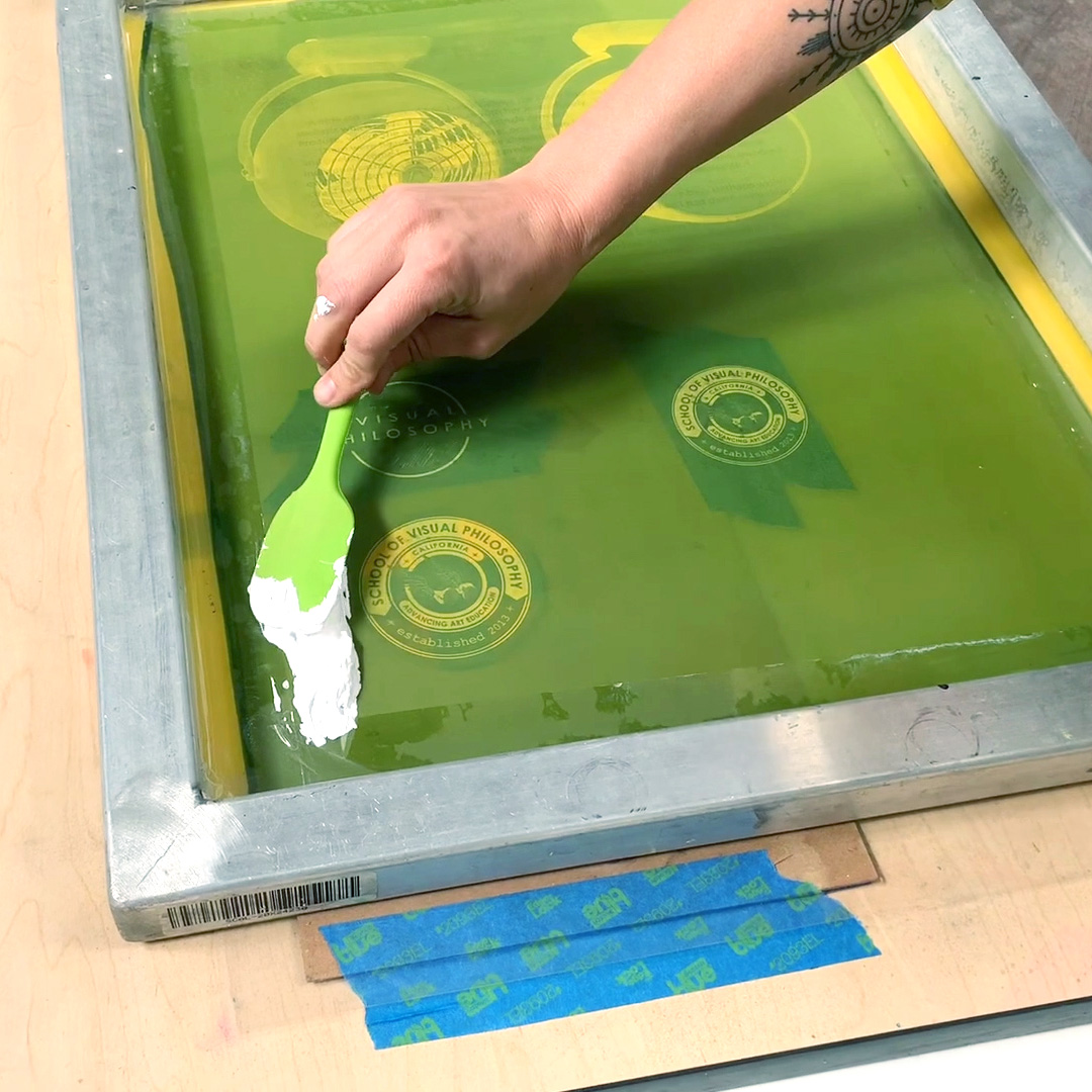 spreading ink on an emulsion silk screen