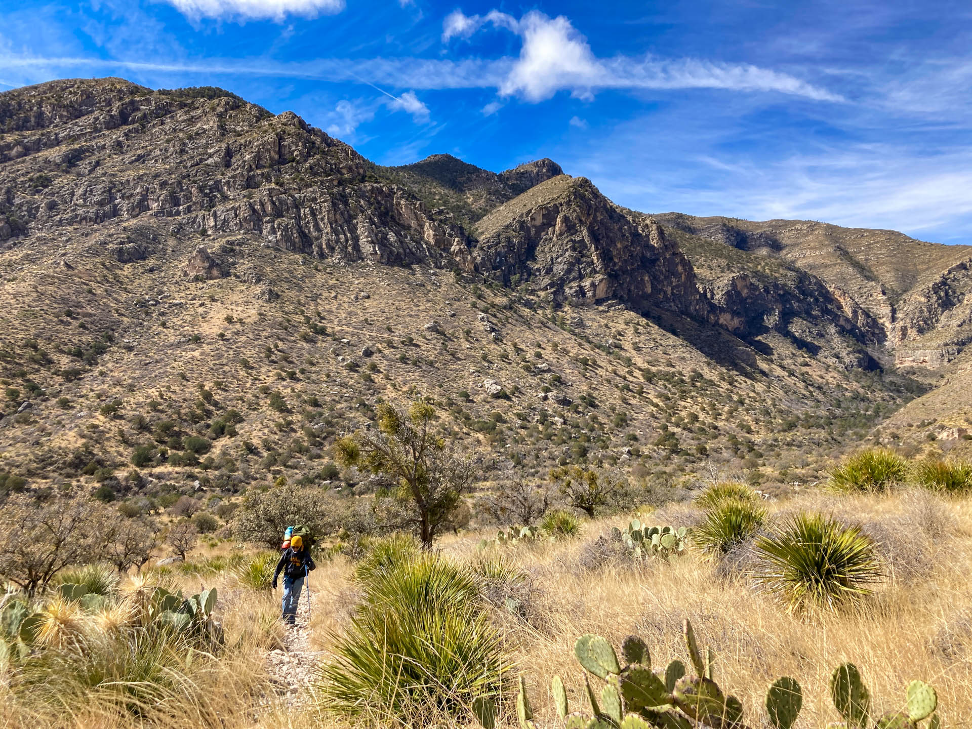  person backpacking away from mountains in Guadalupe Mountains National Park.
