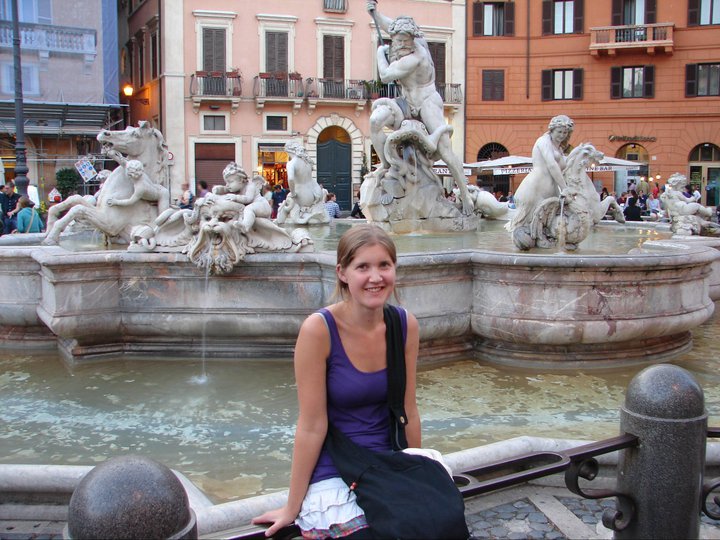 English Language Coach for non-native Teachers of English sitting in front the of the Trevi Fountain