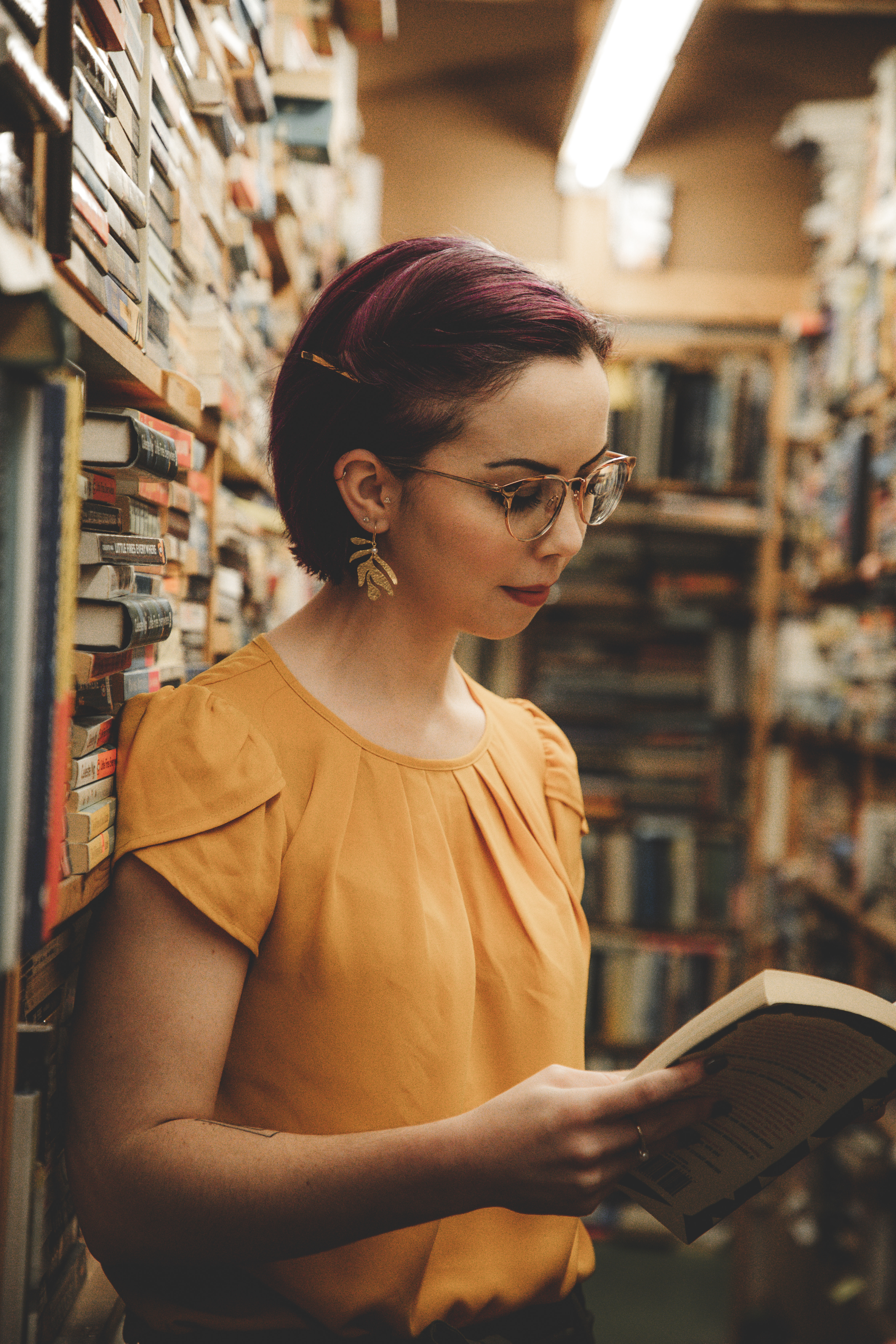 Woman in blazer smiling with bookshelves