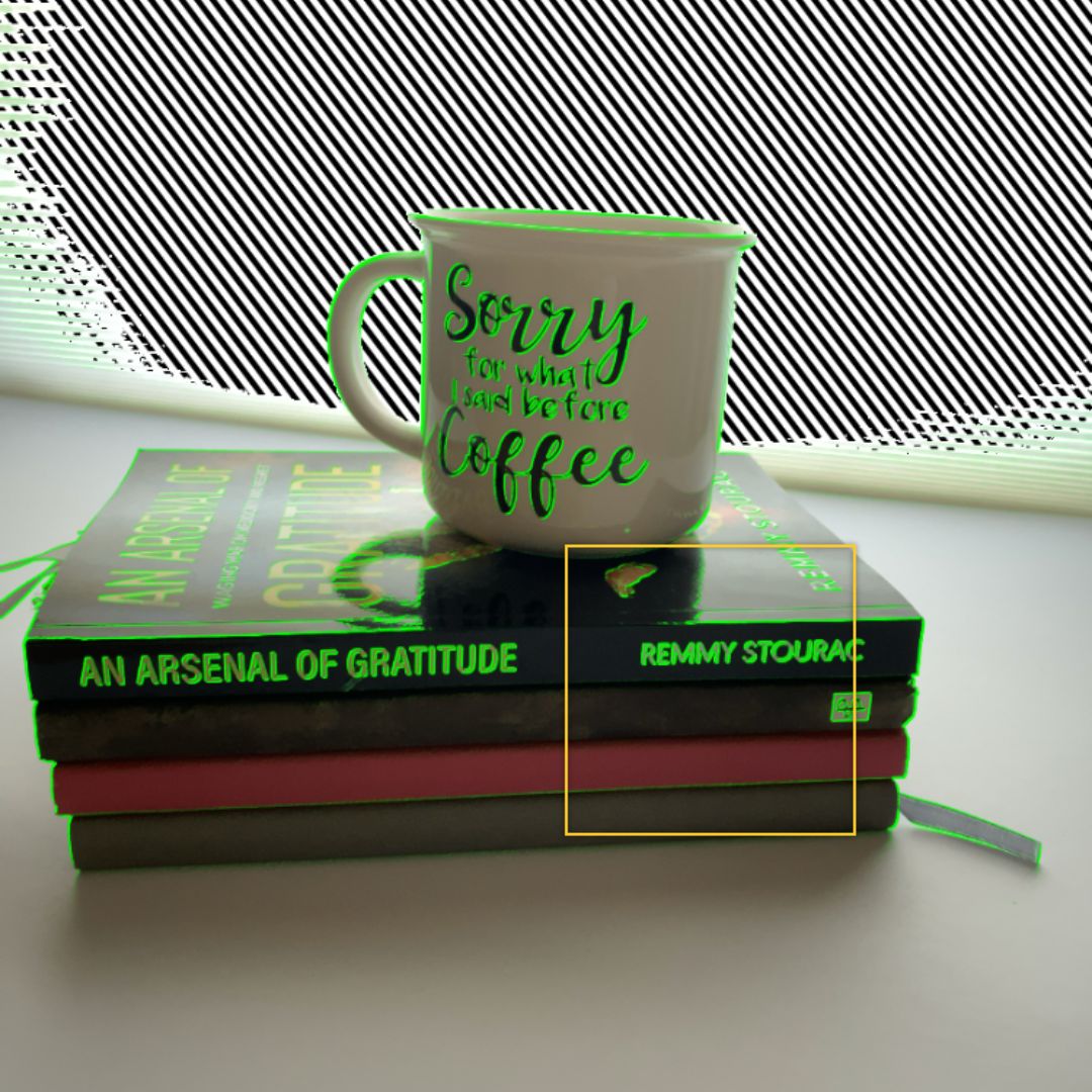 camera focus highlight clippings on 3 paperback books with a coffee mug on top