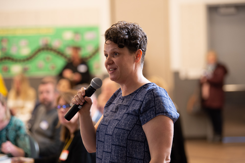 Teacher Delight Specialist addresses a Design Challenge Showcase audience at OMSI in Portland, OR