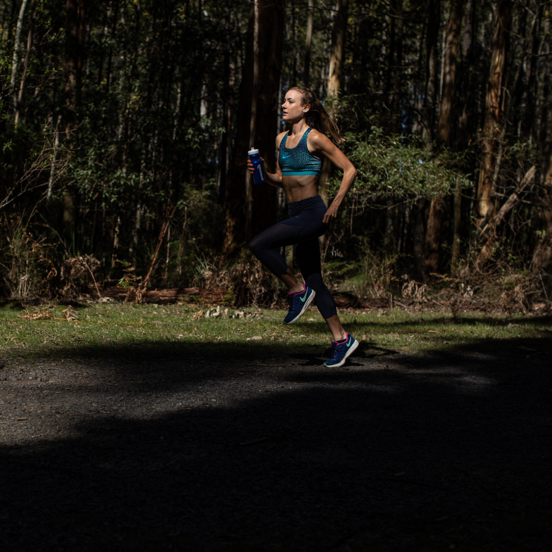 Woman doing calf injury prevention and recovery exercises in outdoor exercise field