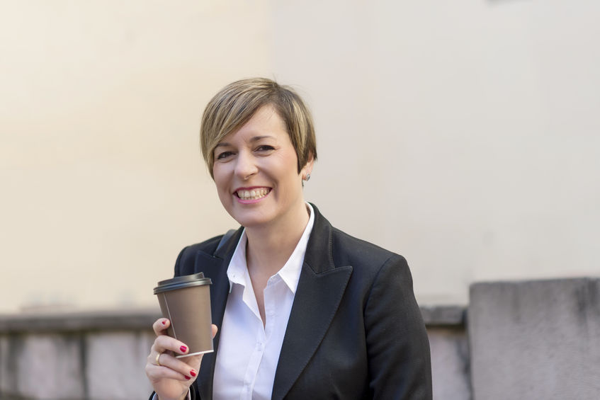 A female principal holding coffee