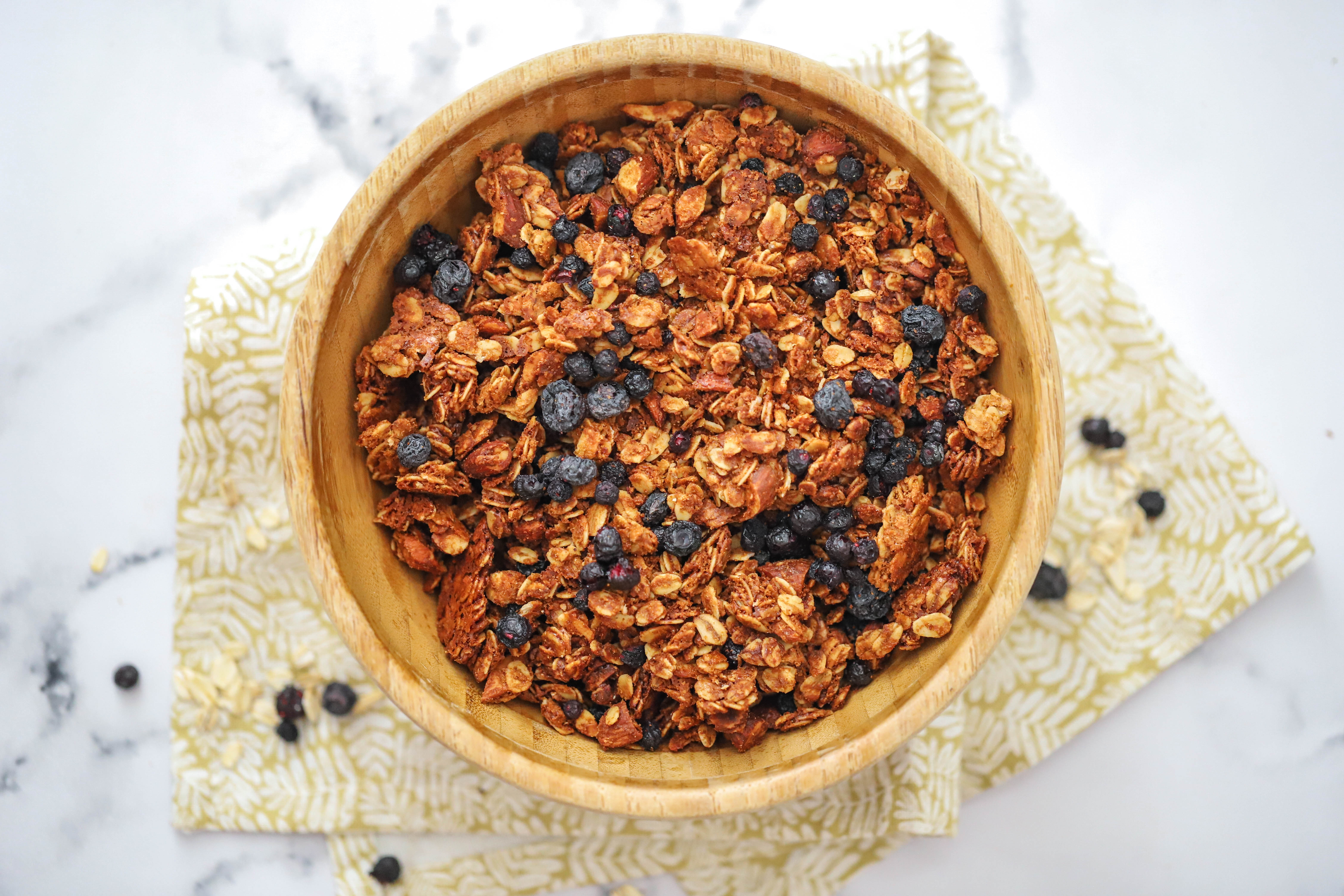 Blueberry Granola in Brown Bowl on White Background