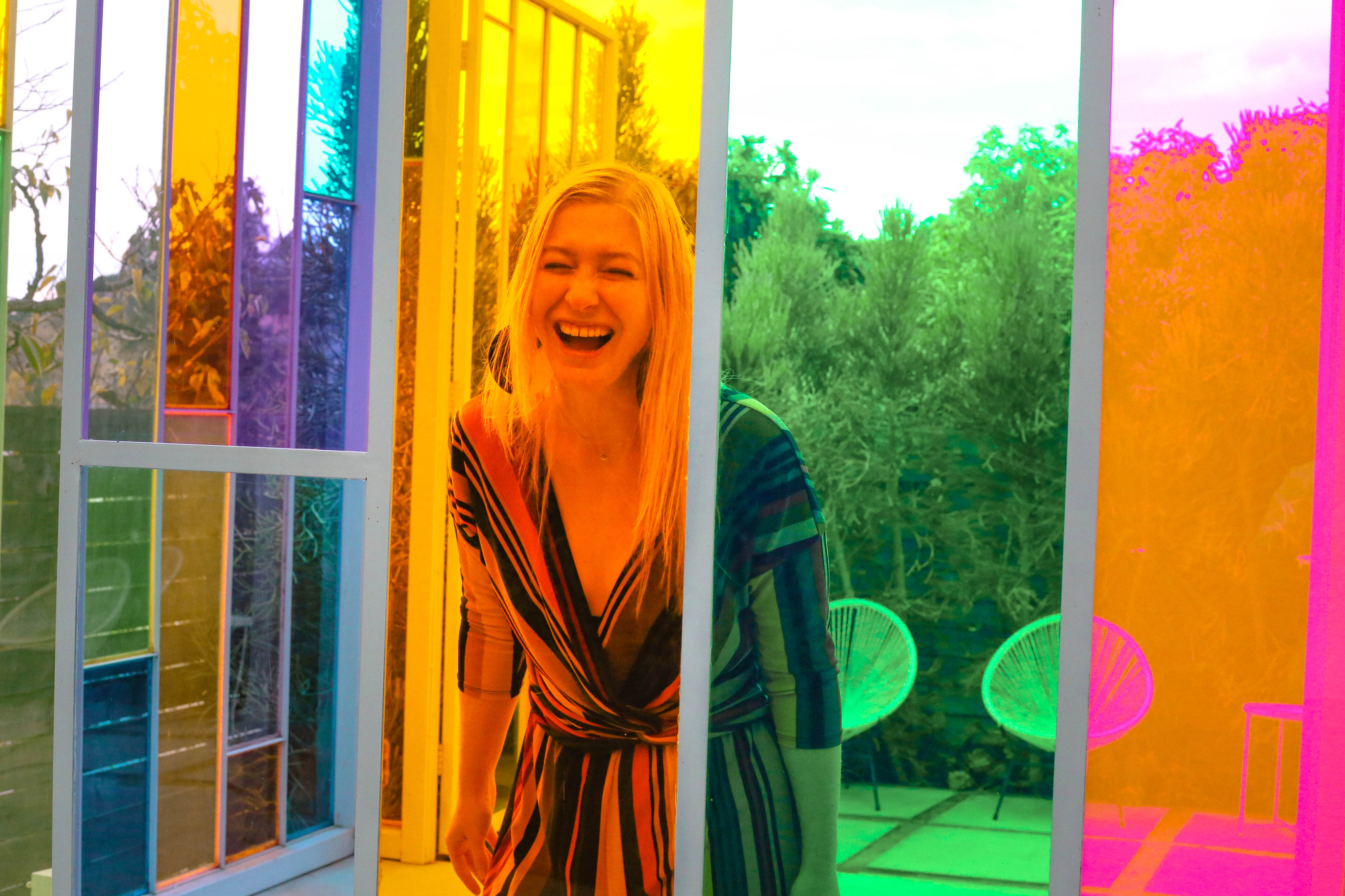 Bunny of Embodied Vibrant Living Yelling in Joy Through a Rainbow Window at The Chroma Cabana