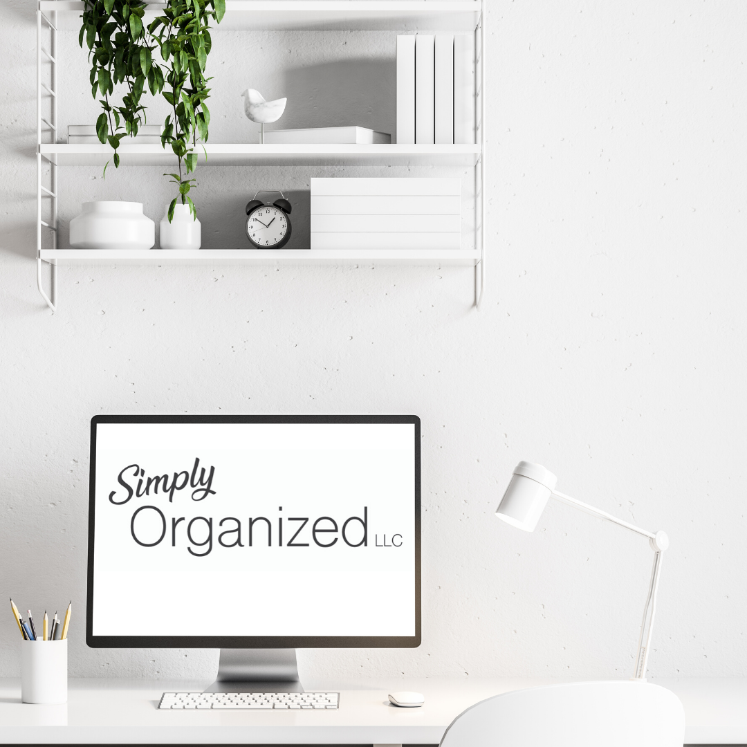 desktop computer, white walls and furniture, simply organized logo on monitor, green ivy