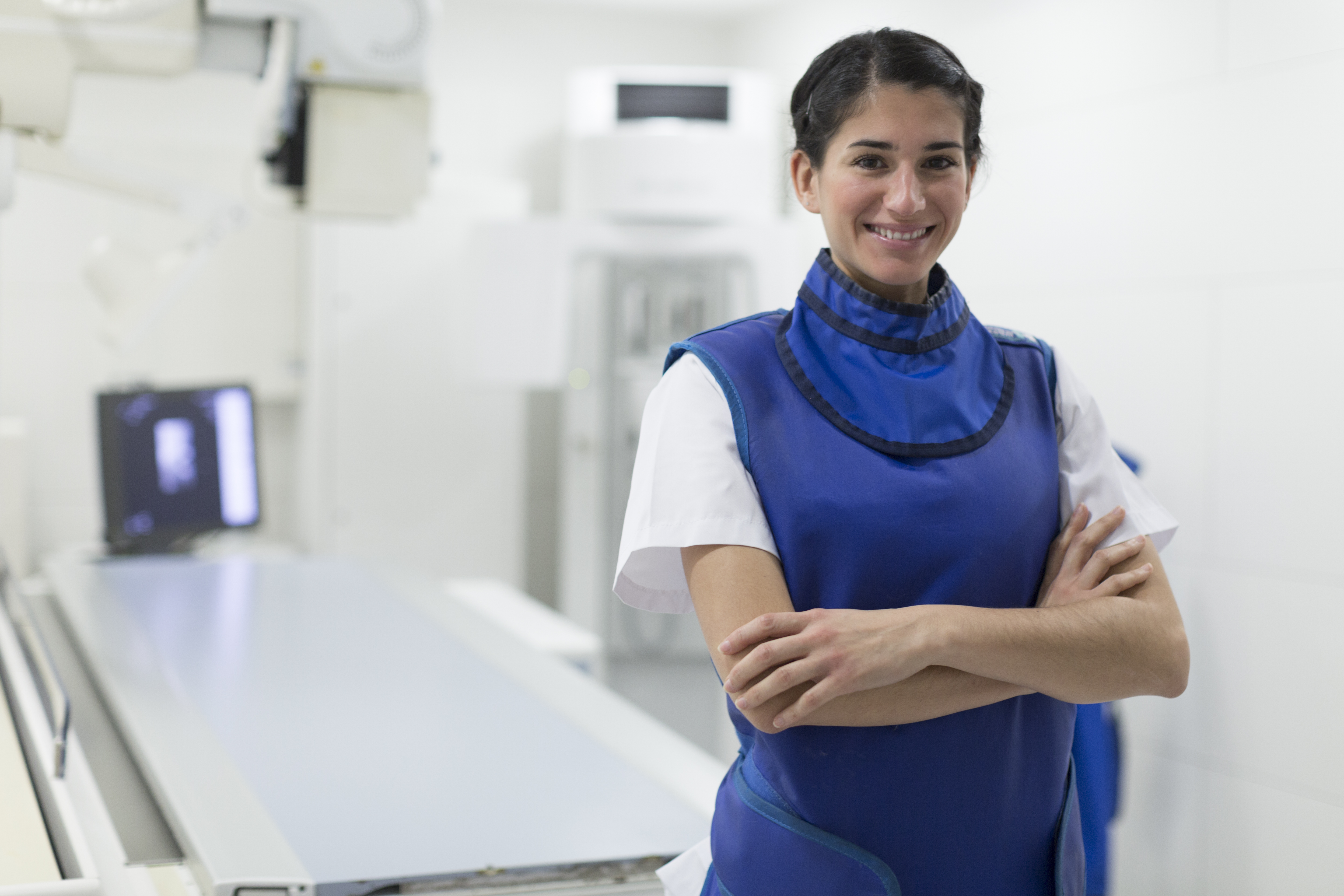 Radiology technician in front of X-ray machine