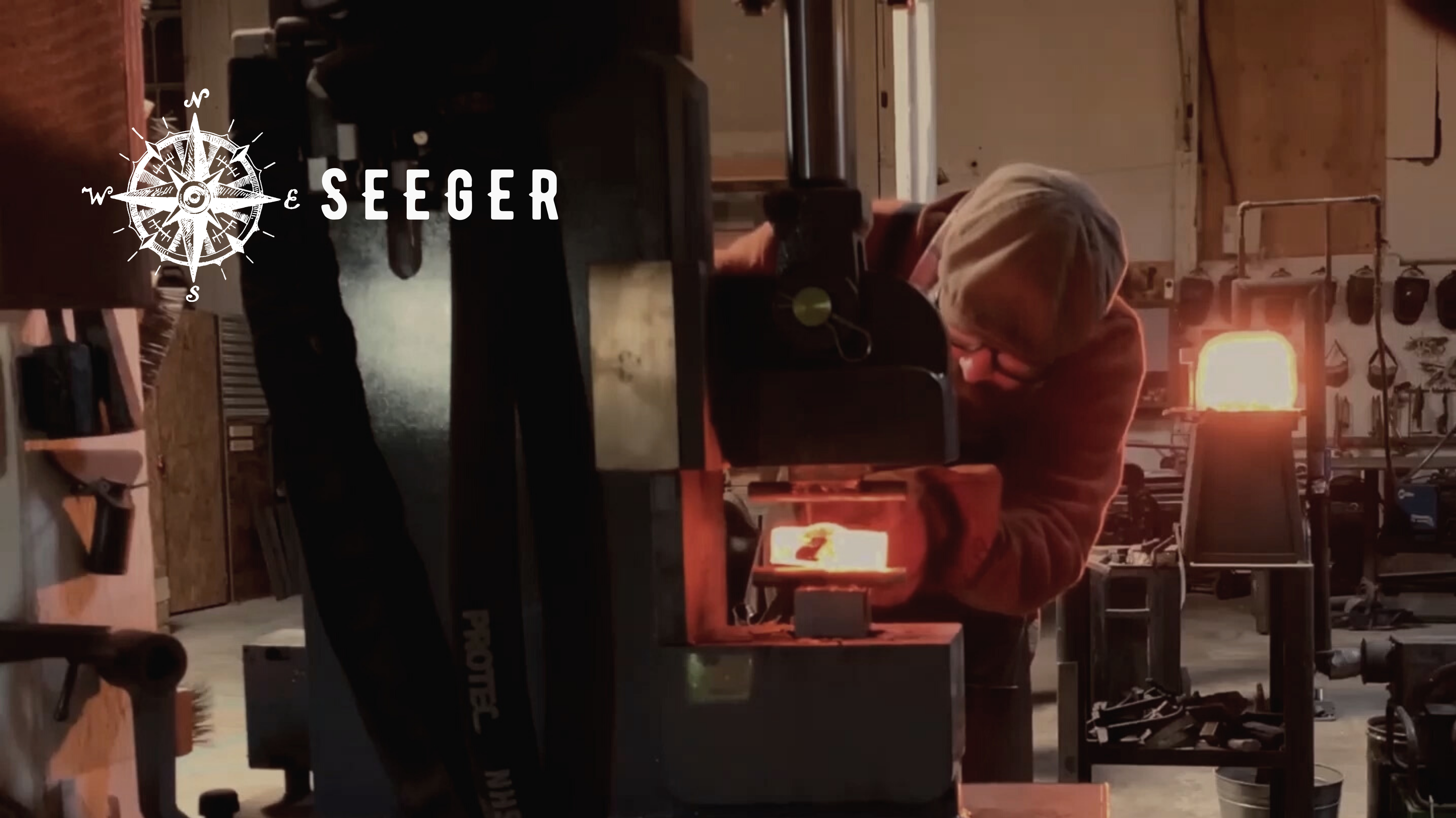 Yori Seeger using the hydraulic press to make a hammer