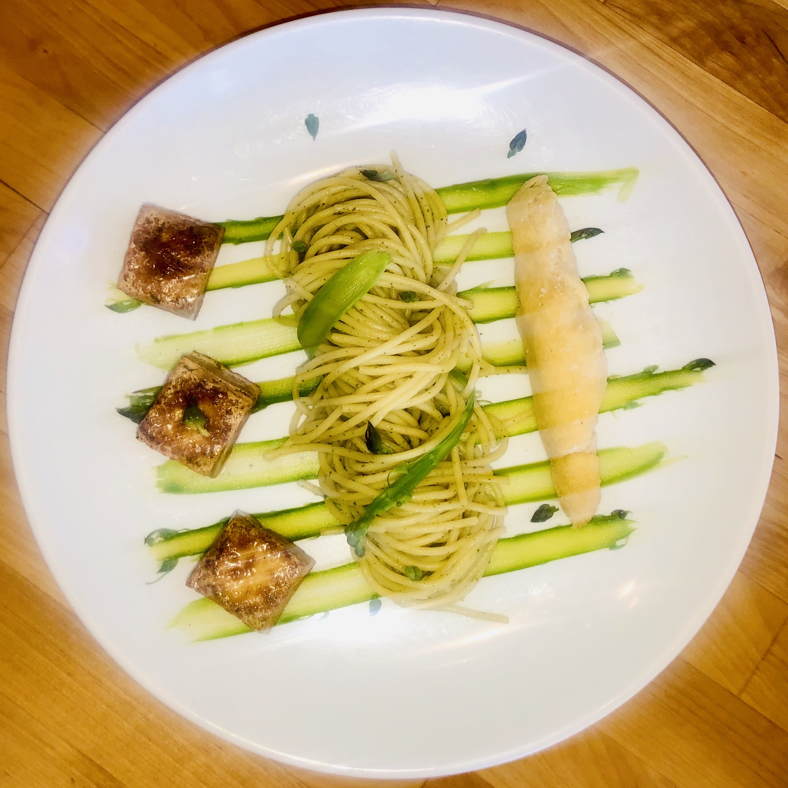Pesto Spaghetti Pasta with thinly shaved asparagus, fried garlic butter tofu squares and toasted breadstick.