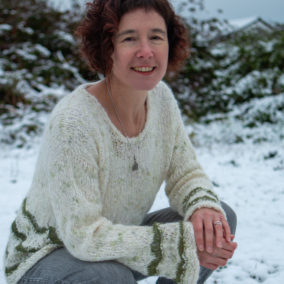 Carol Feller wearing the Duvet Day sweater and smiling at the camera. 