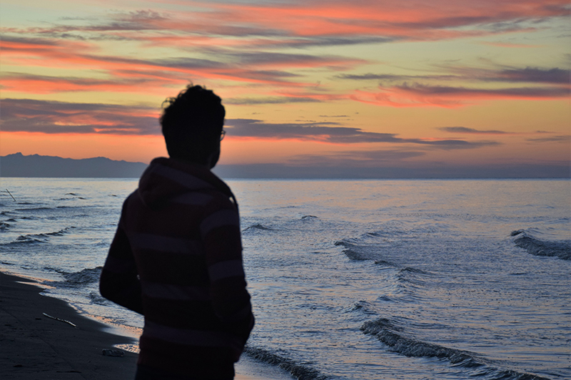 A man looking at the ocean