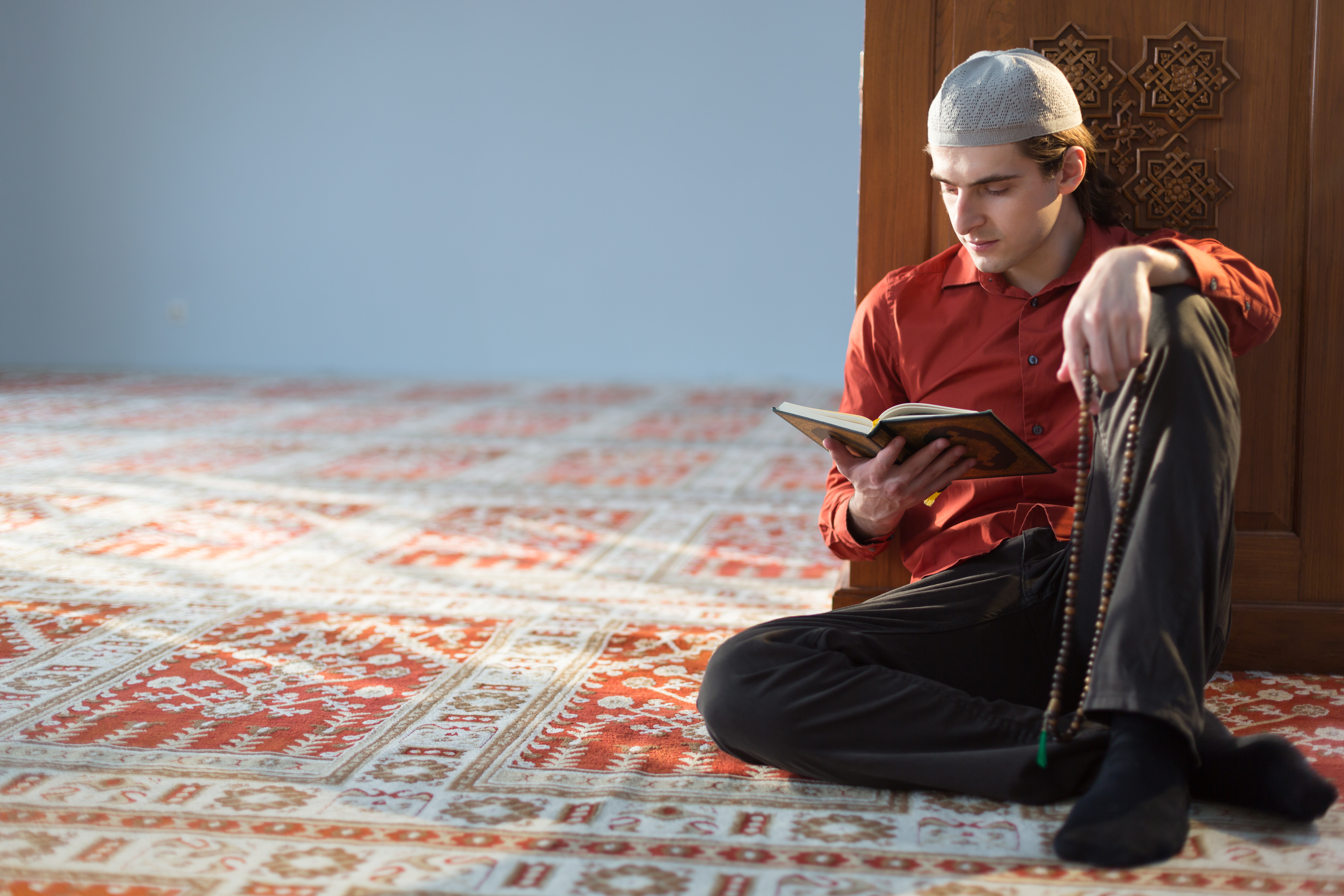 white man reading Quran