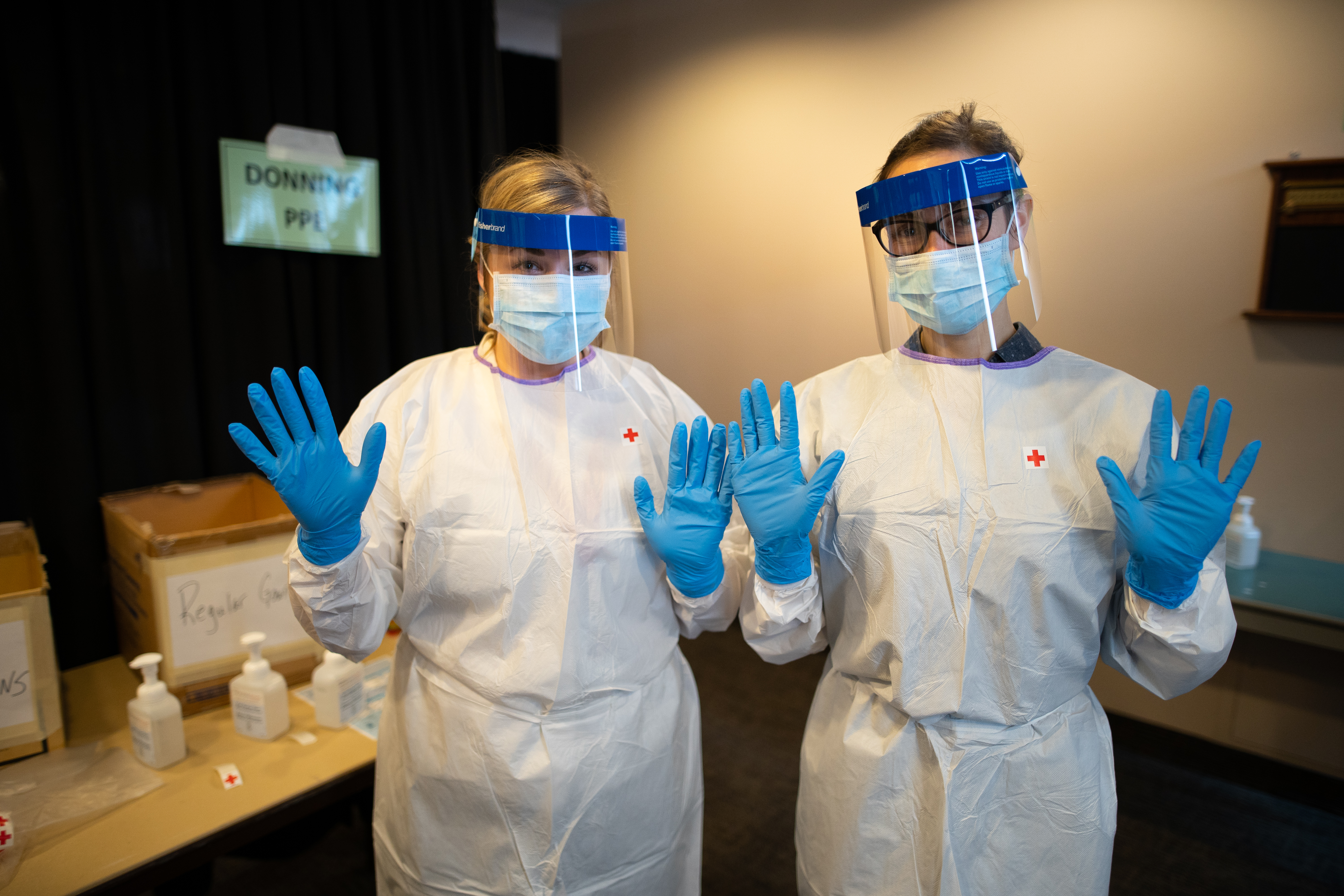 two persons wearing personal protective equipment