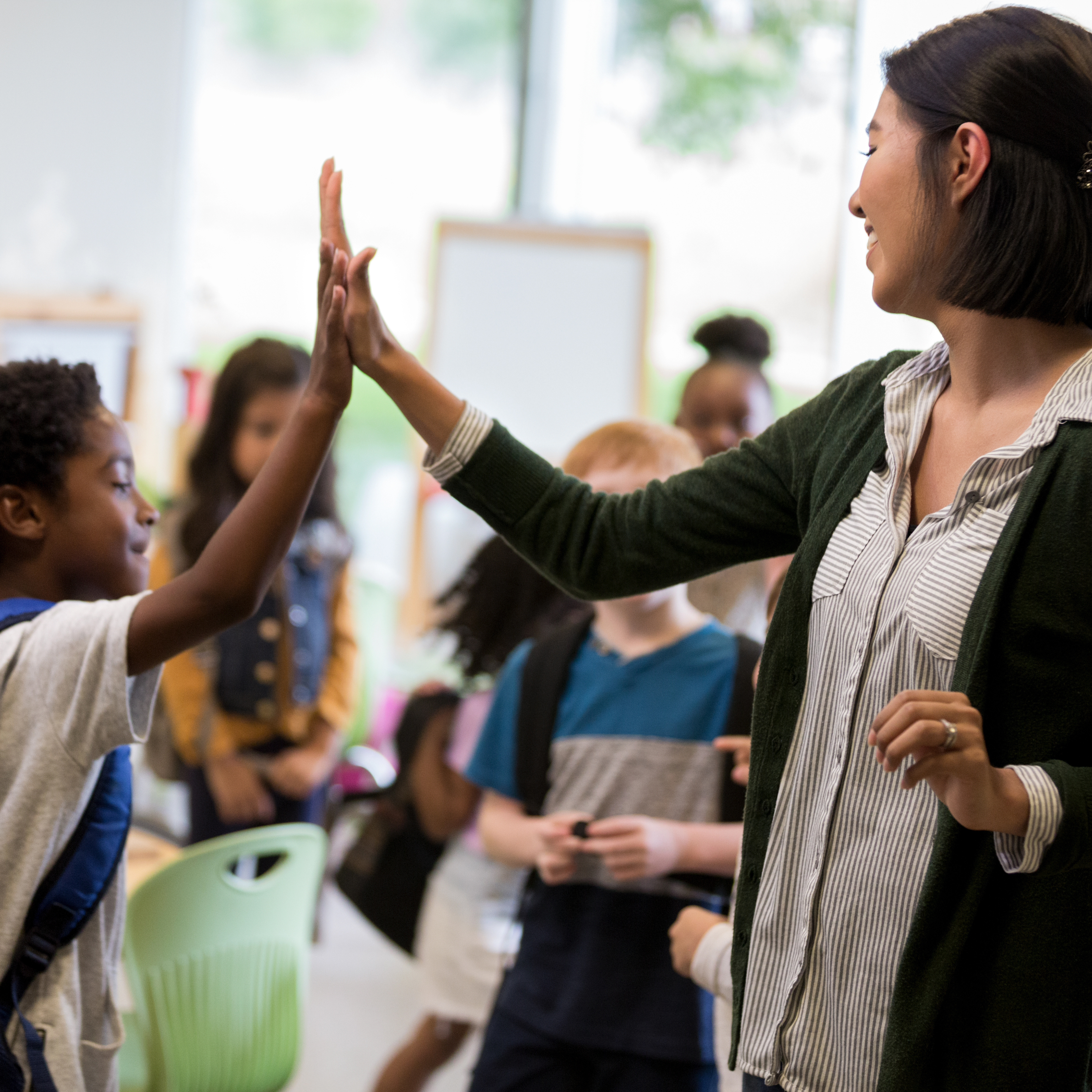 teacher high fiving student