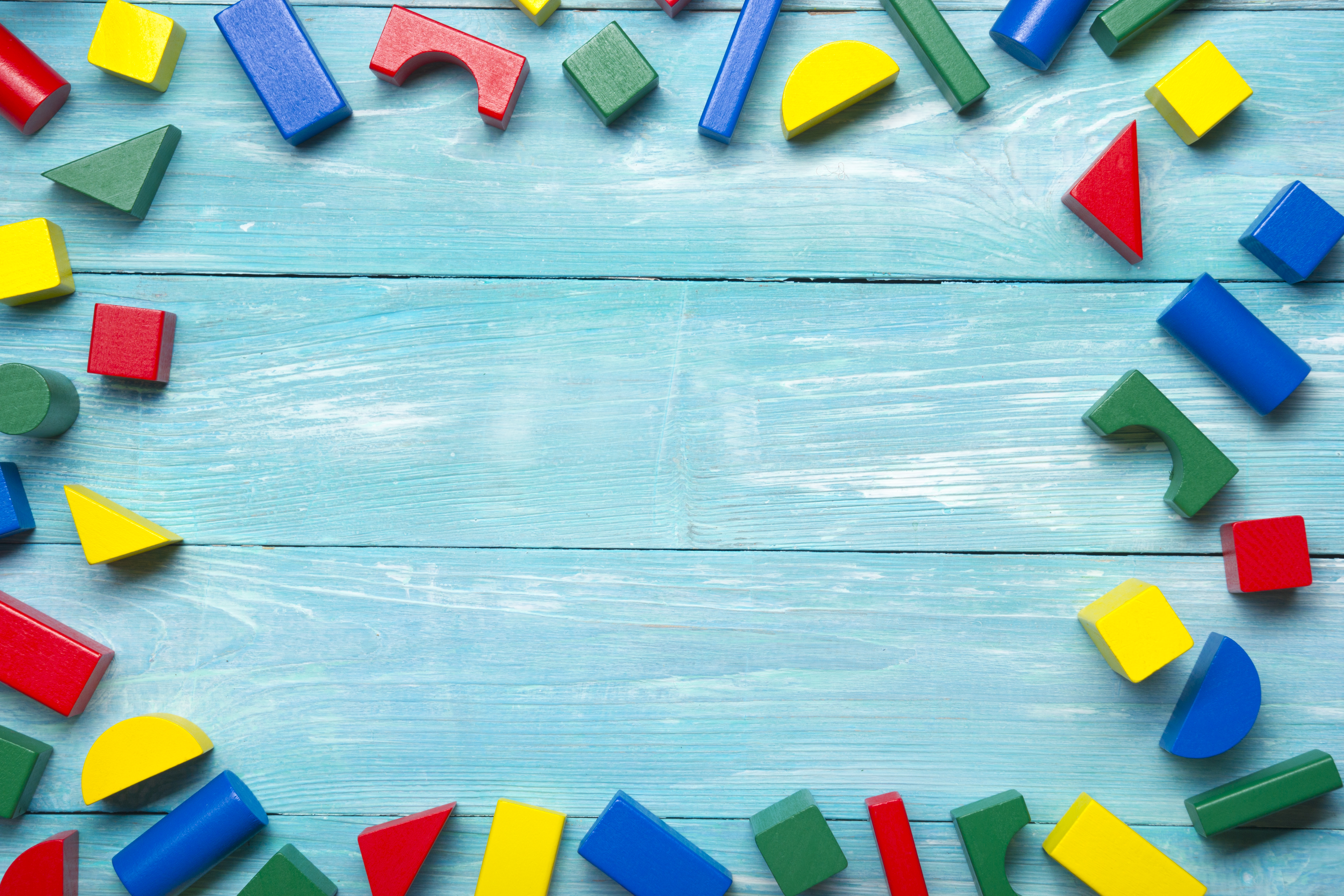 Blue wood background with primary colored blocks around