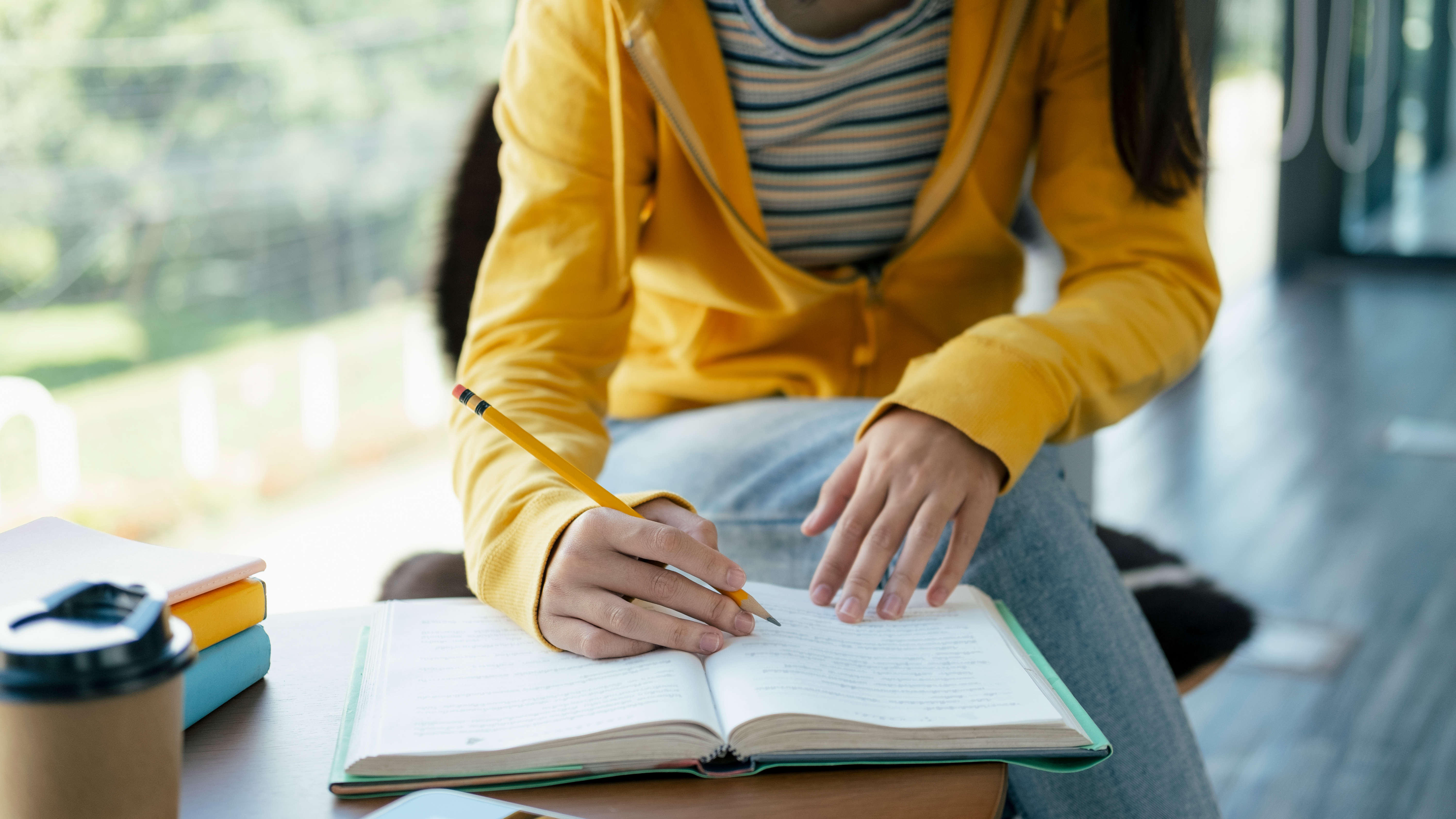 student writing in notebook