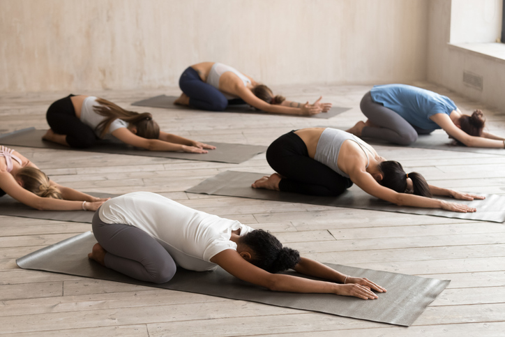 Diverse yoga class with students in child's pose