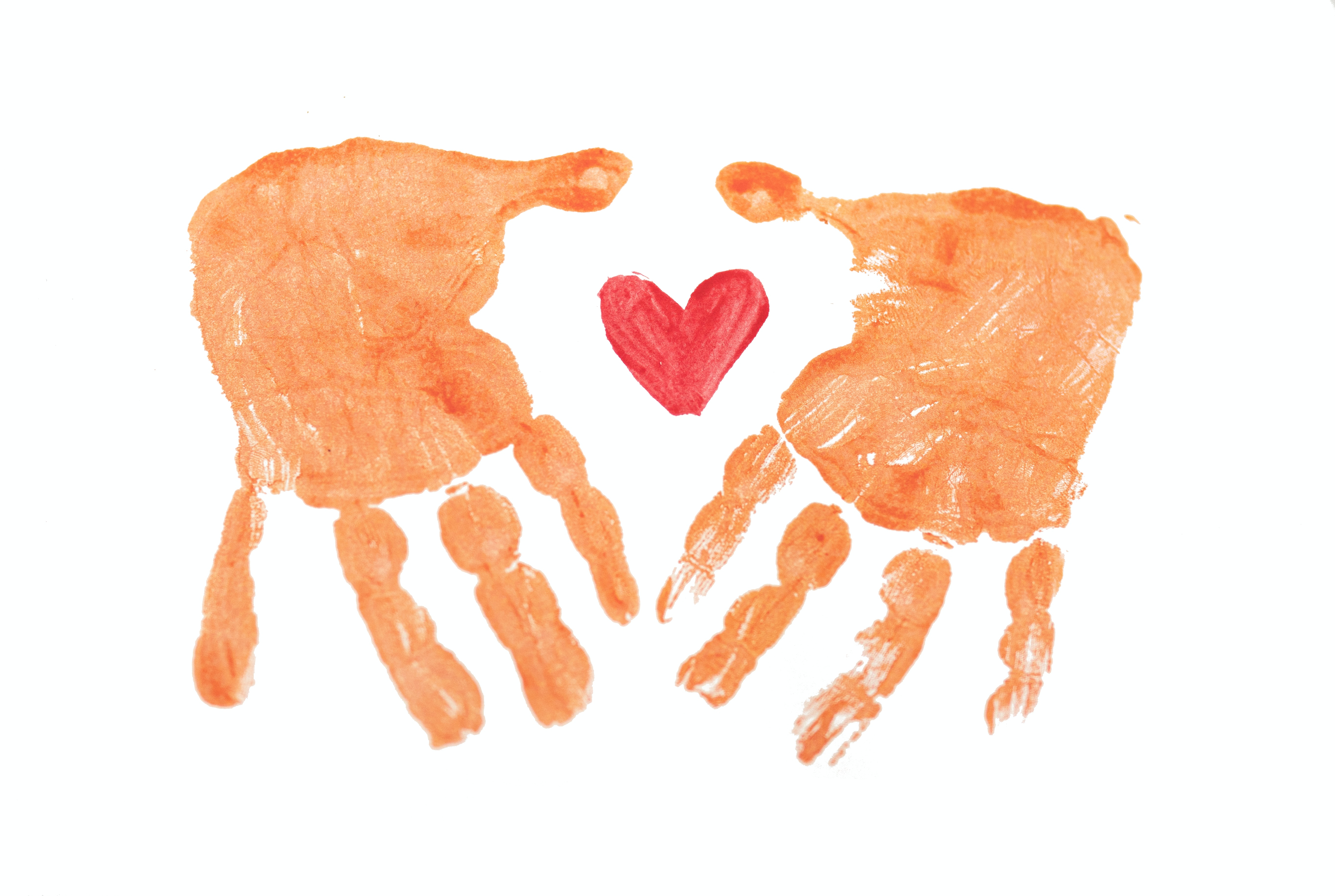 handprints holding heart