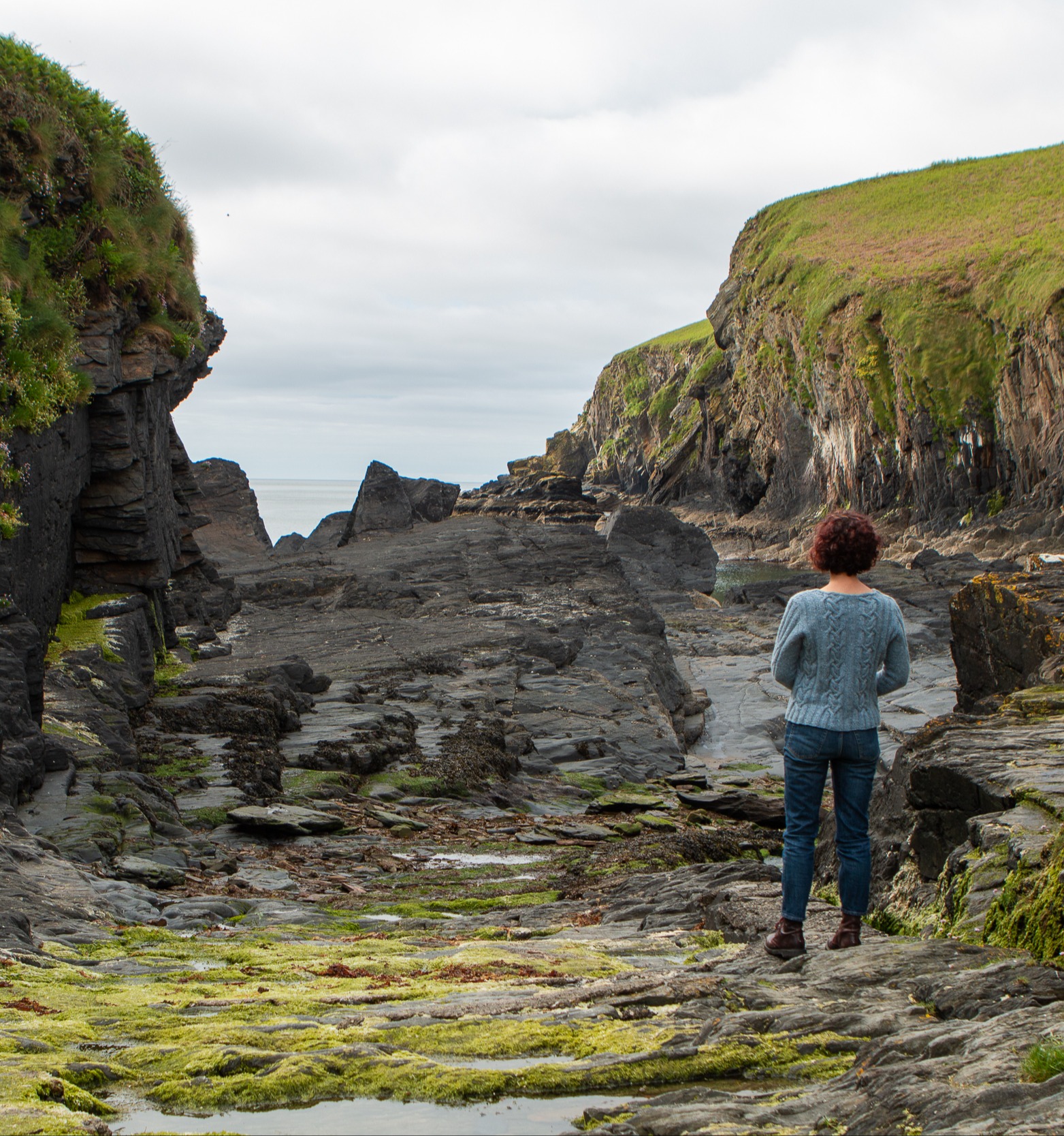 Carol Feller wearing the Bere Sweater while lookng out to the sea.