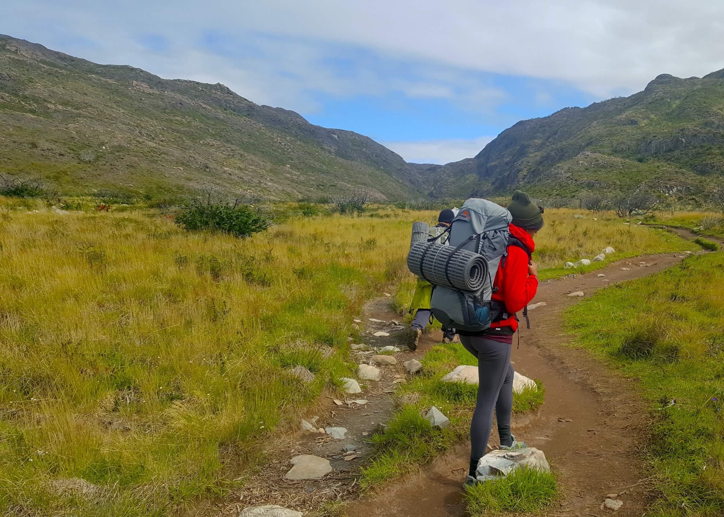 Woman hiking outdoors with gear in torres del paine national park