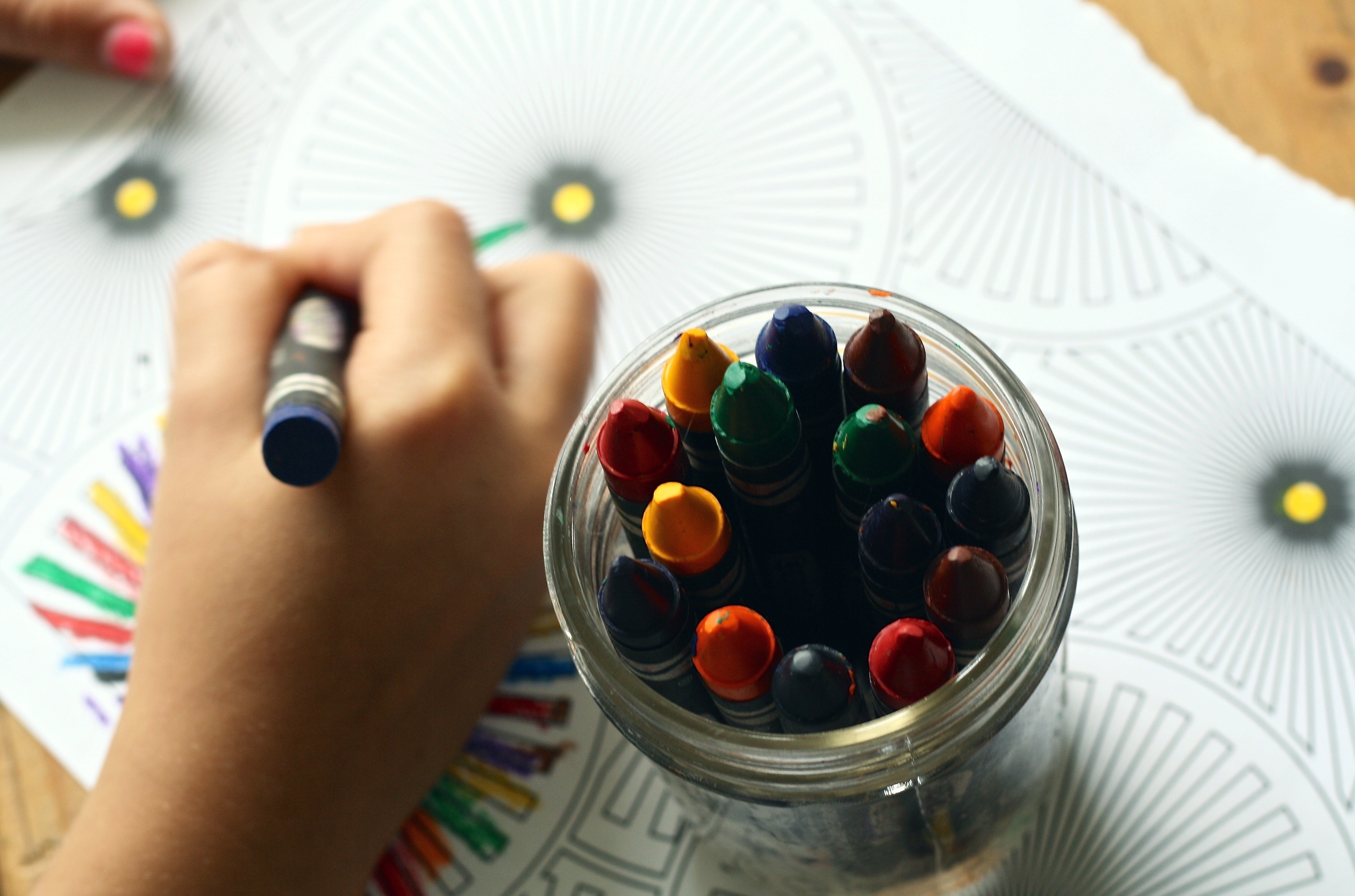 student coloring with crayons