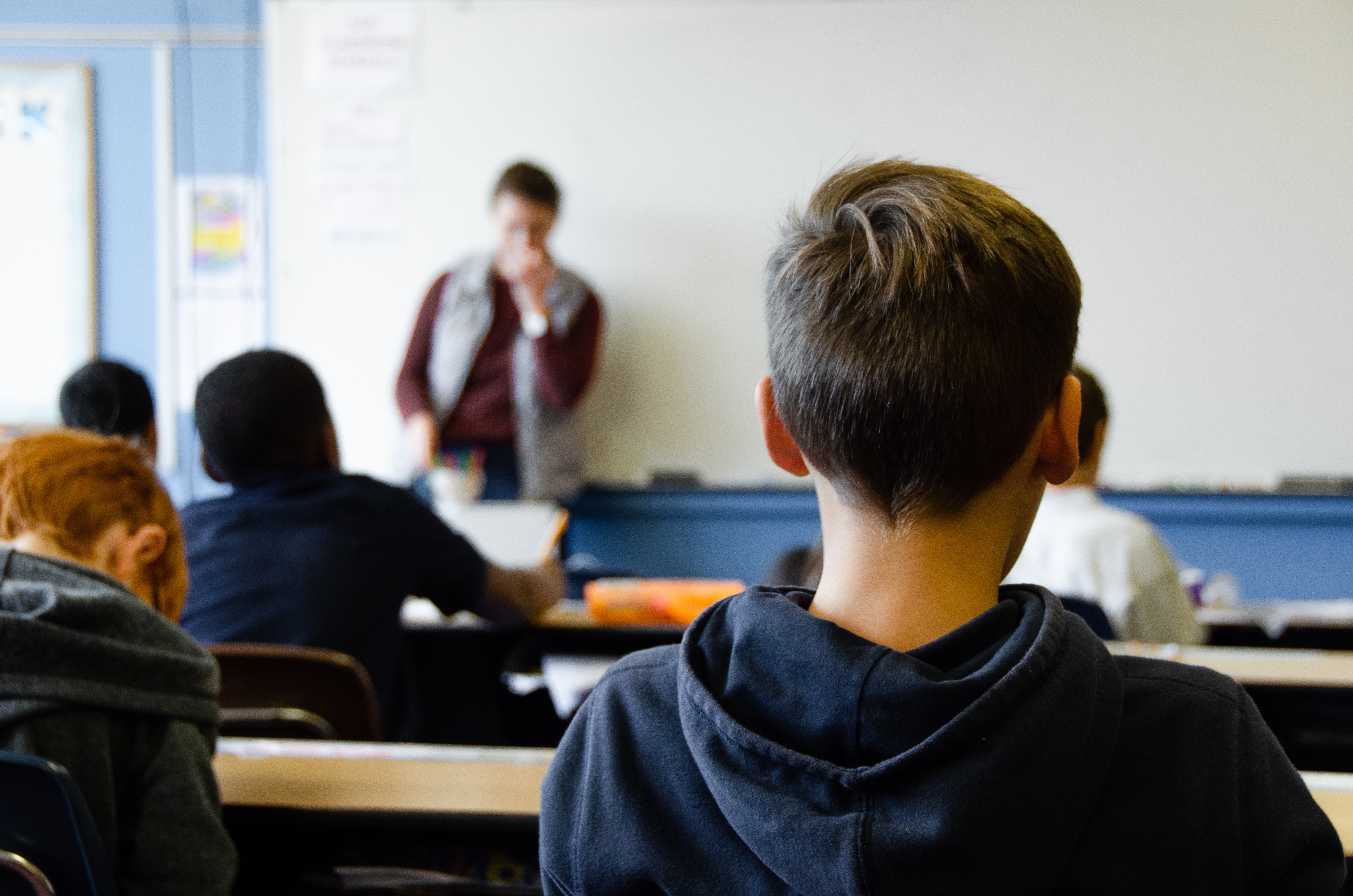 View of classroom from behind students head