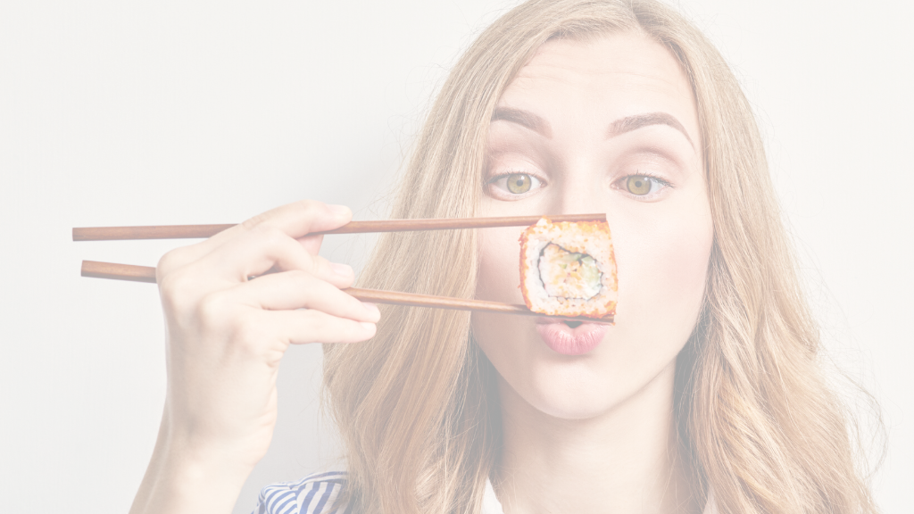 Woman holding sushi with chopsticks 