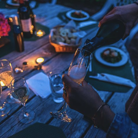 Dinner party outside by candle light 
