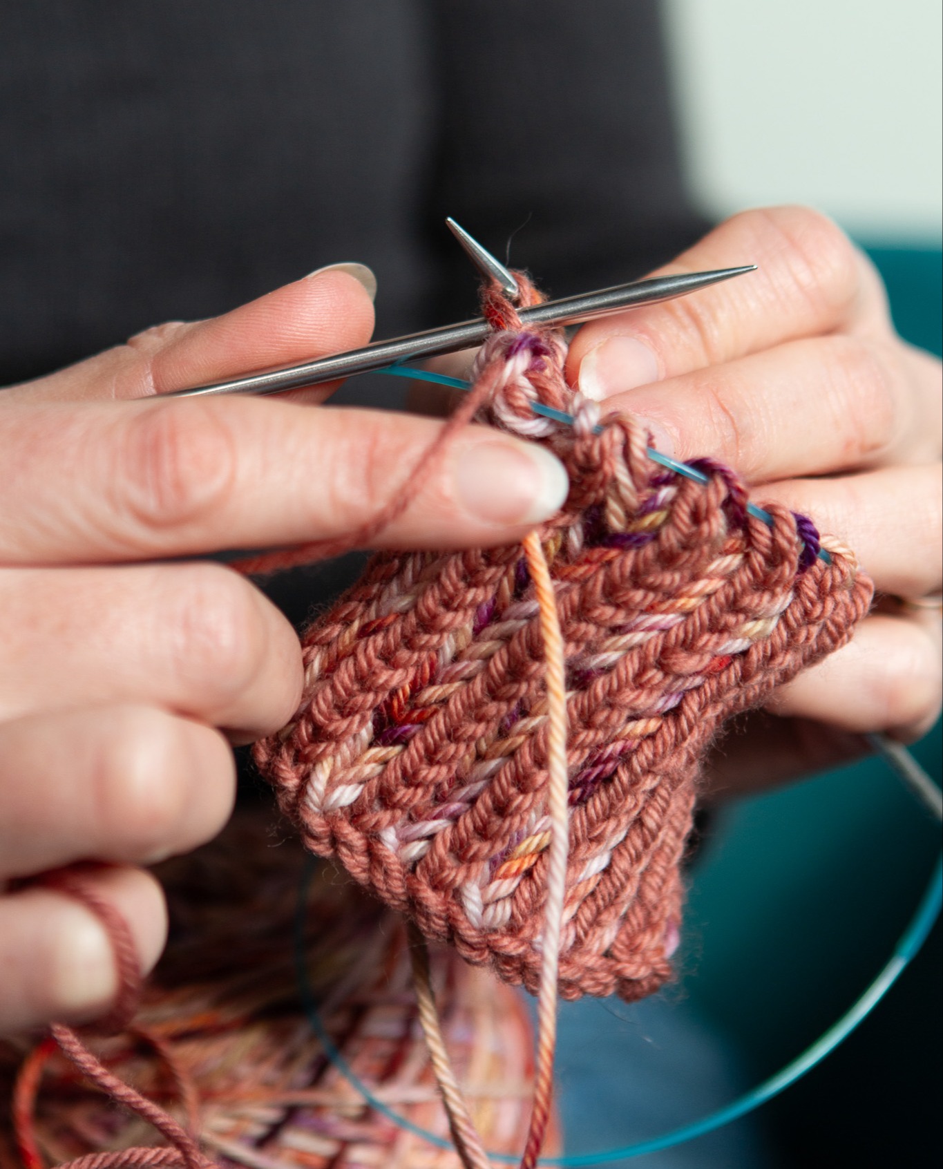Close up of the Seasonal yarn option on a set of knitting needles.