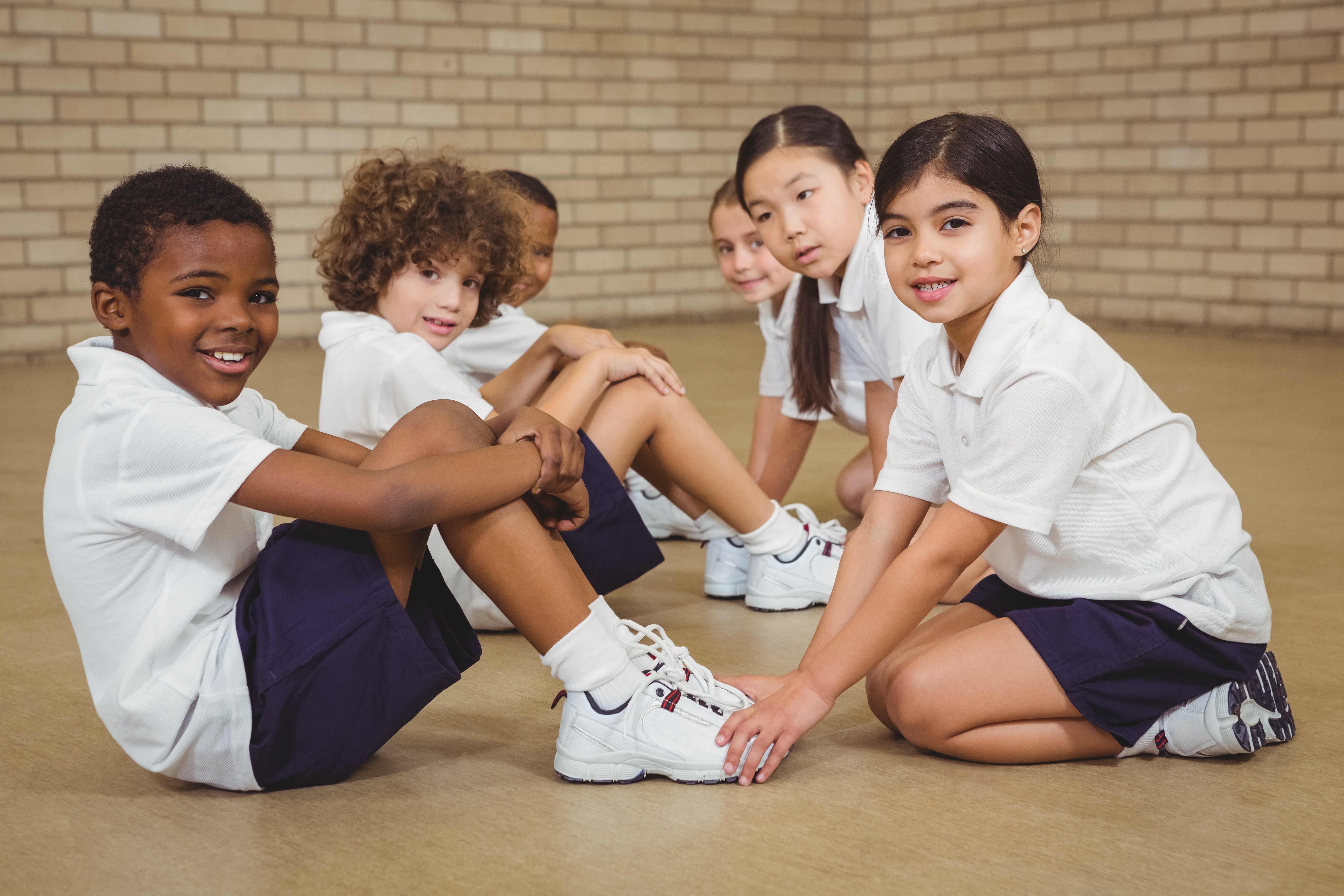 Children performing sit-ups in PE