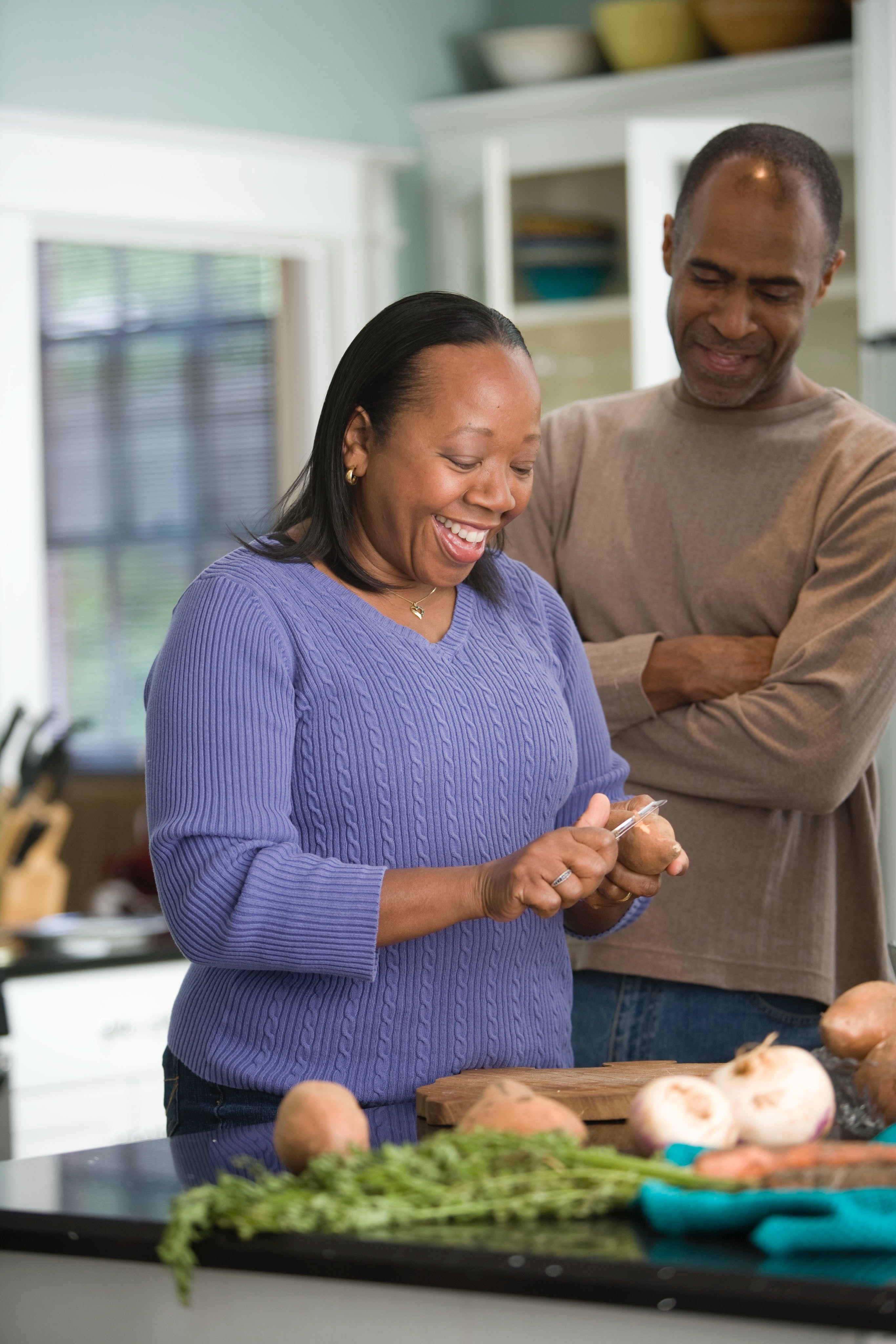 woman and man preparing food at a counter