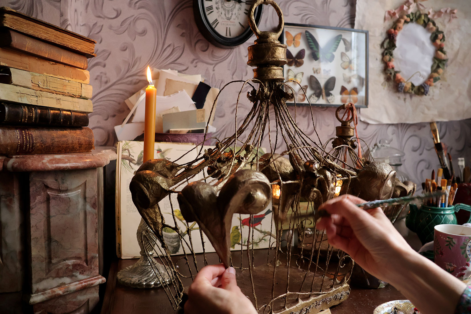 painting a baroque paper cage 