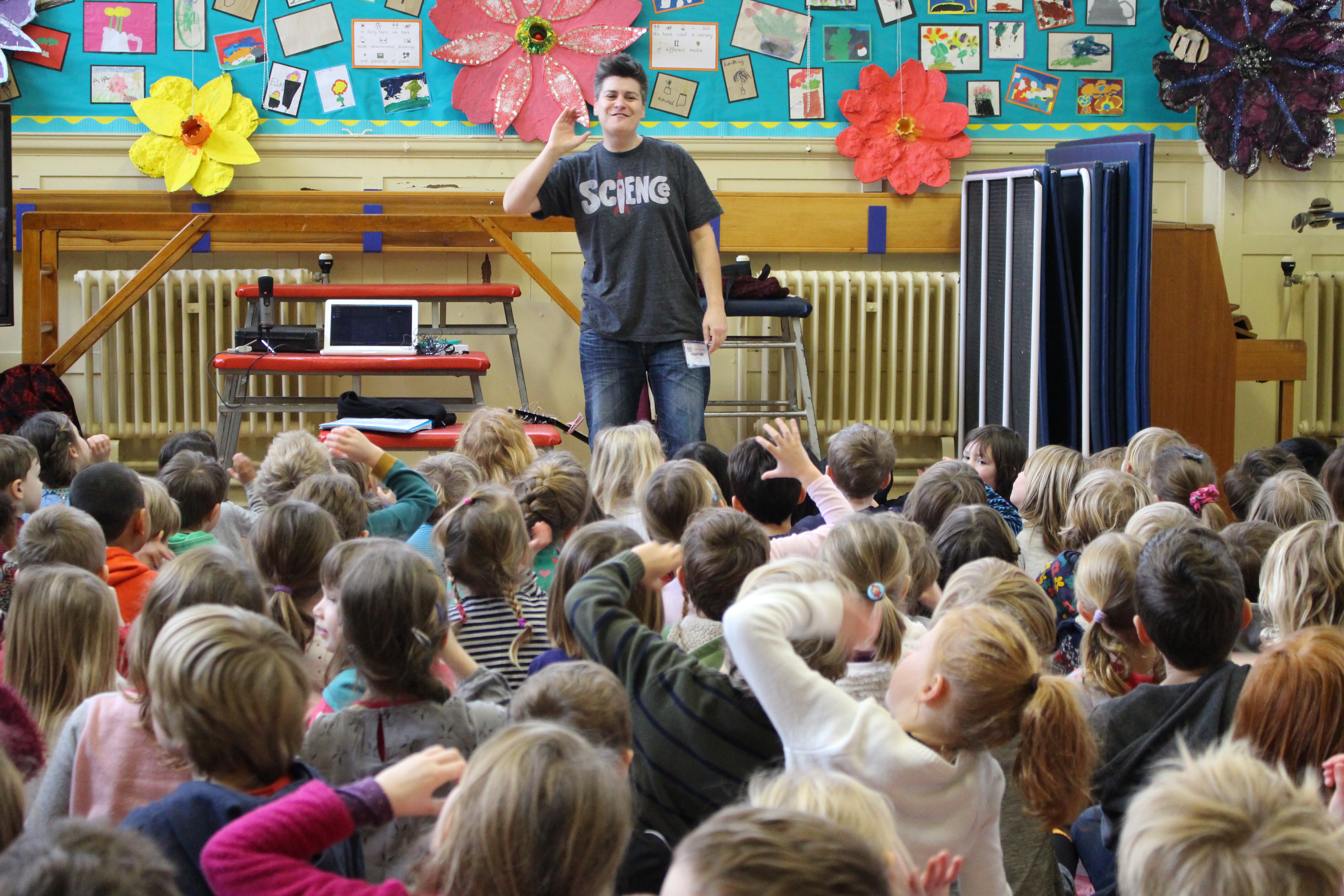 image of Al Start leading singing assembly with children singing and signing along