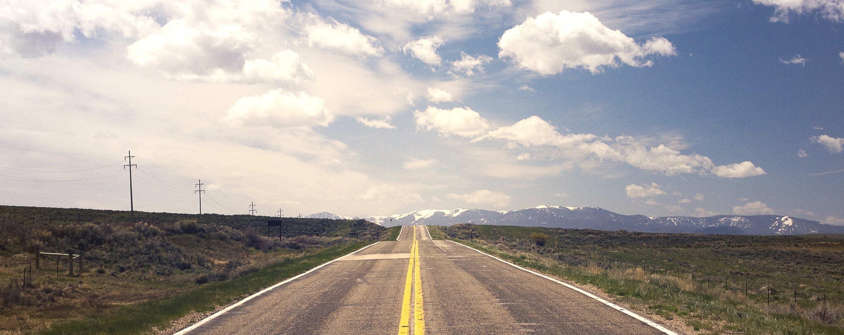 two lane road, leading to a mountain, cloudy sky, nothing to see here