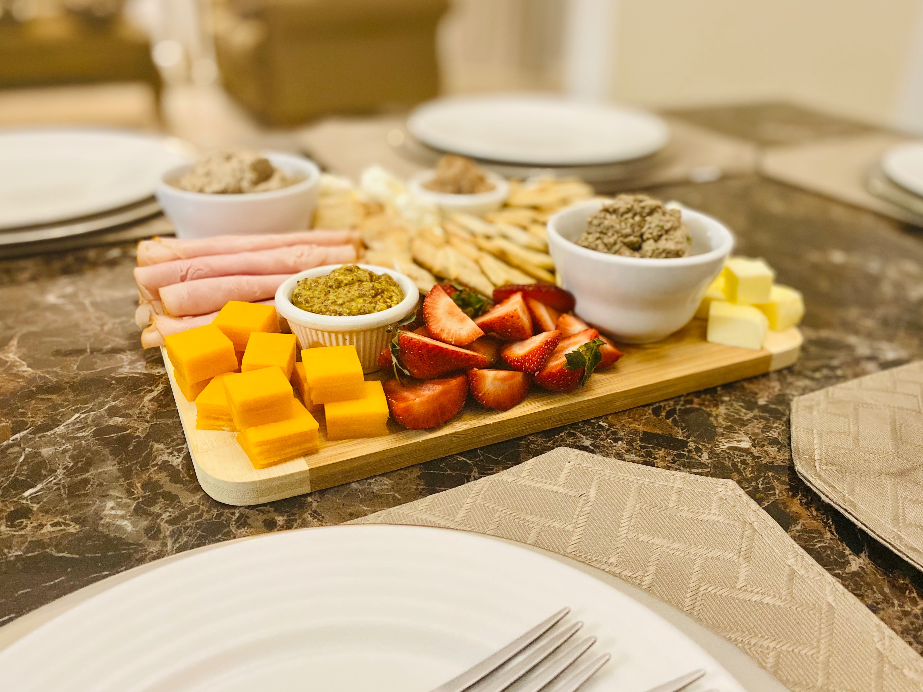 A charcuterie board that I made in my farm to table course with chicken liver, mushroom and homemade mustard.