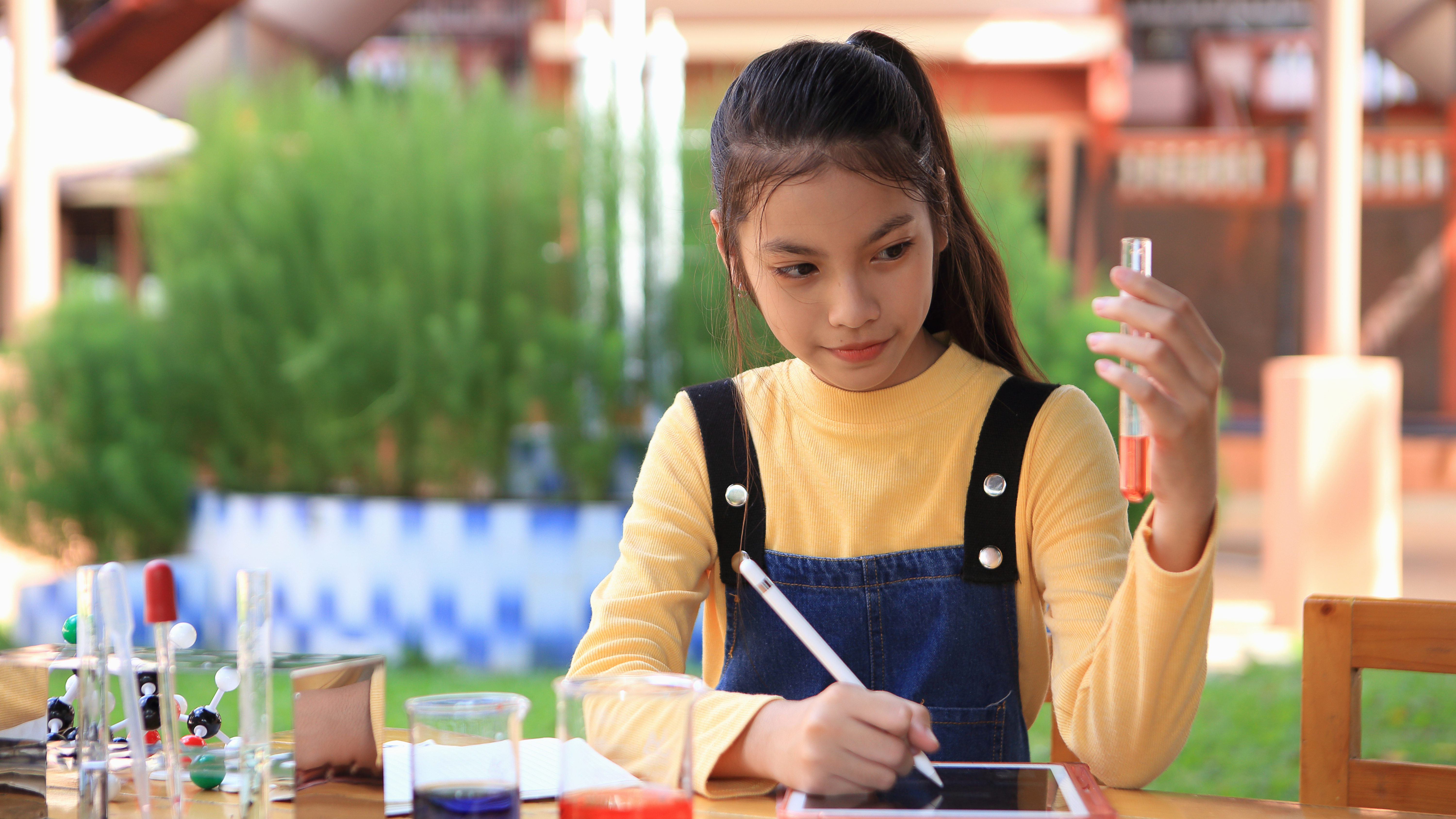 girl conducting experiments with test tube