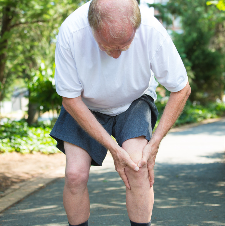 Old man holding his knee in pain due to knee osteoarthritis which develops with age.