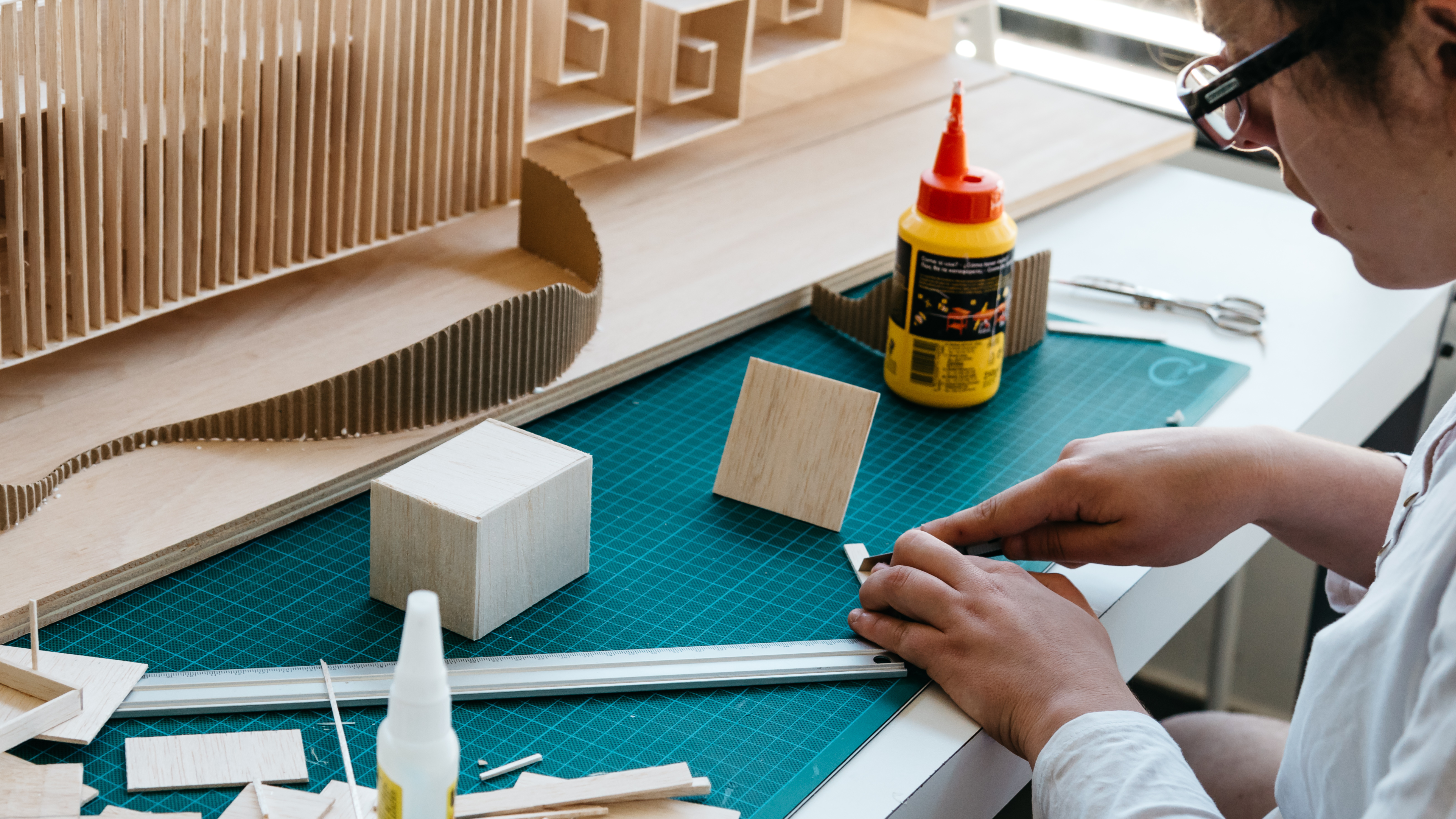 man using wood tools to construct something