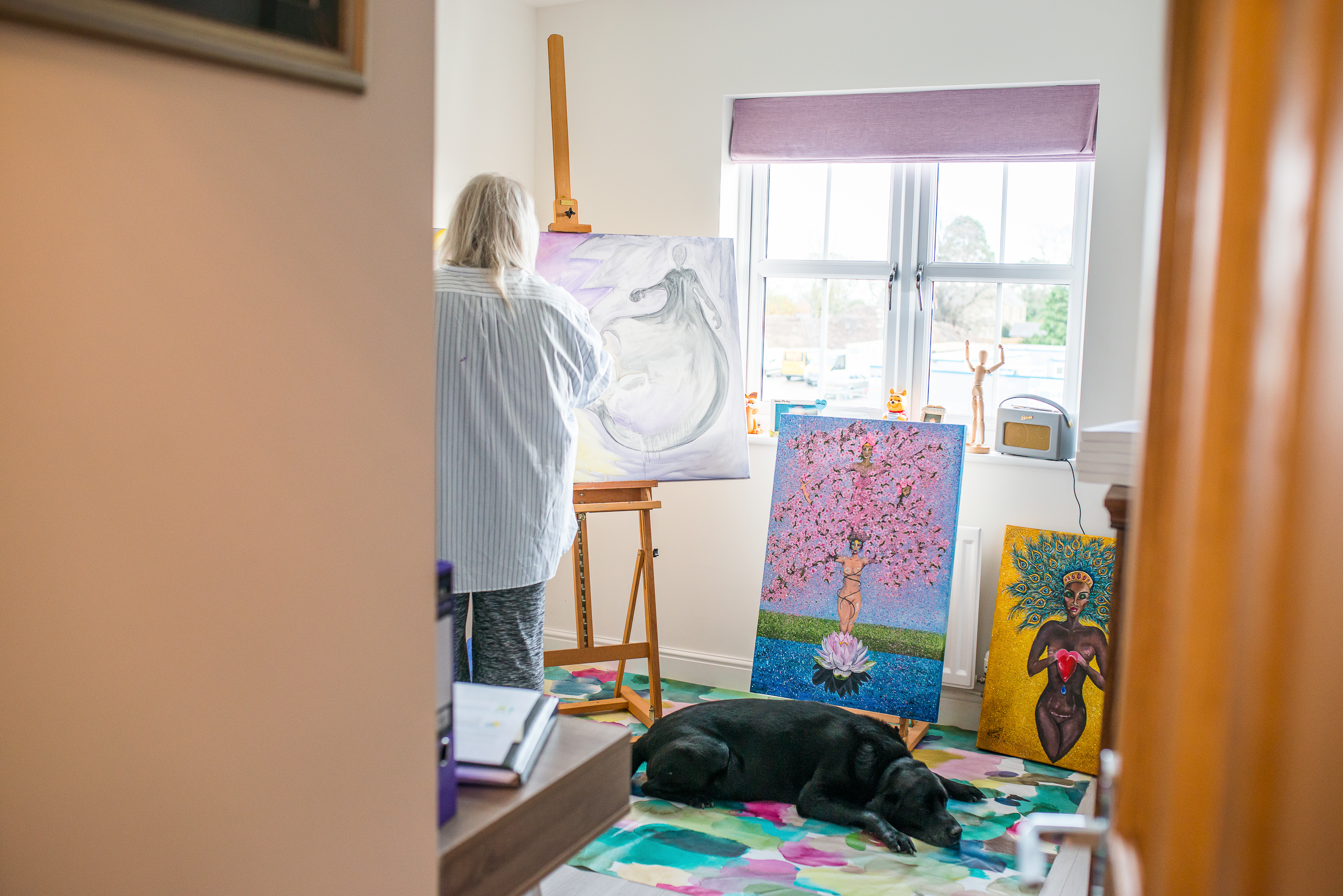 picture of a woman and dog in an art studio